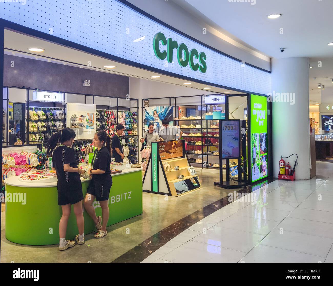 Crocs retail store with white branding and a distinctive green display ...