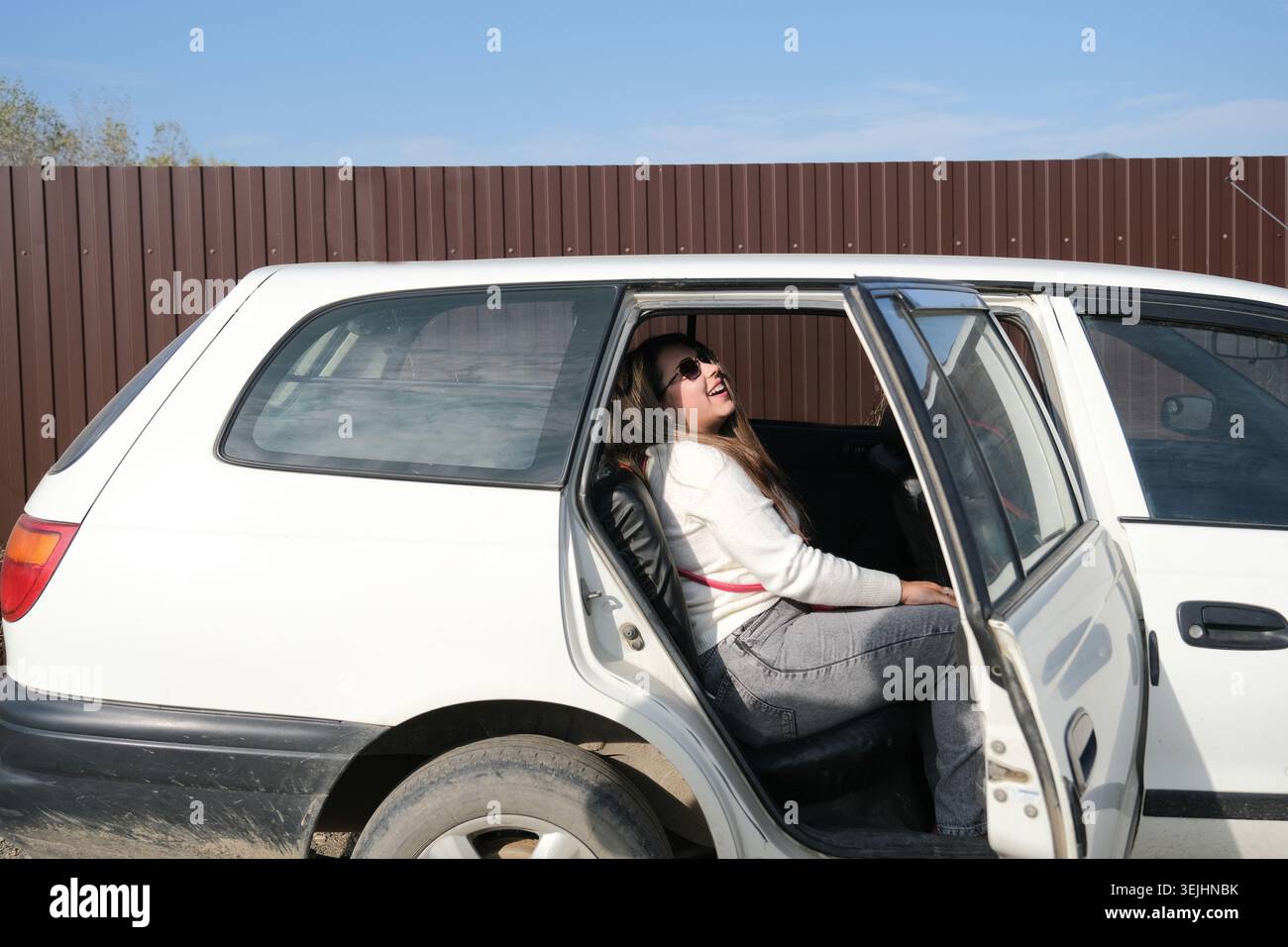 Beautiful woman laughing in car hi-res stock photography and images - Alamy