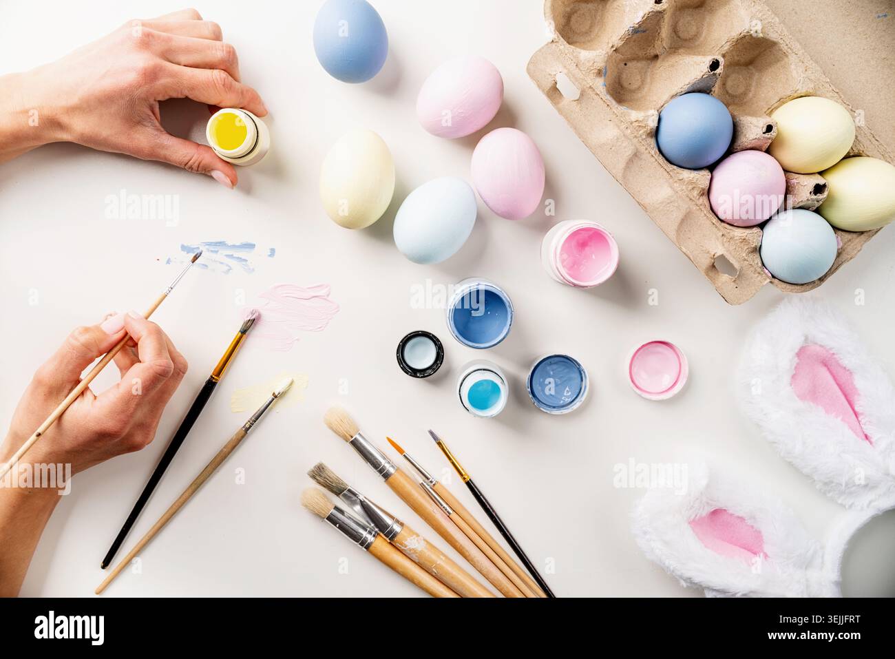 Easter background with eggs with pastel paints, top view flat lay Stock Photo