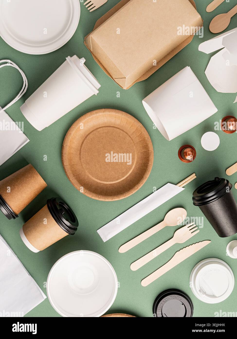 Eco friendly disposable tableware on green background Stock Photo