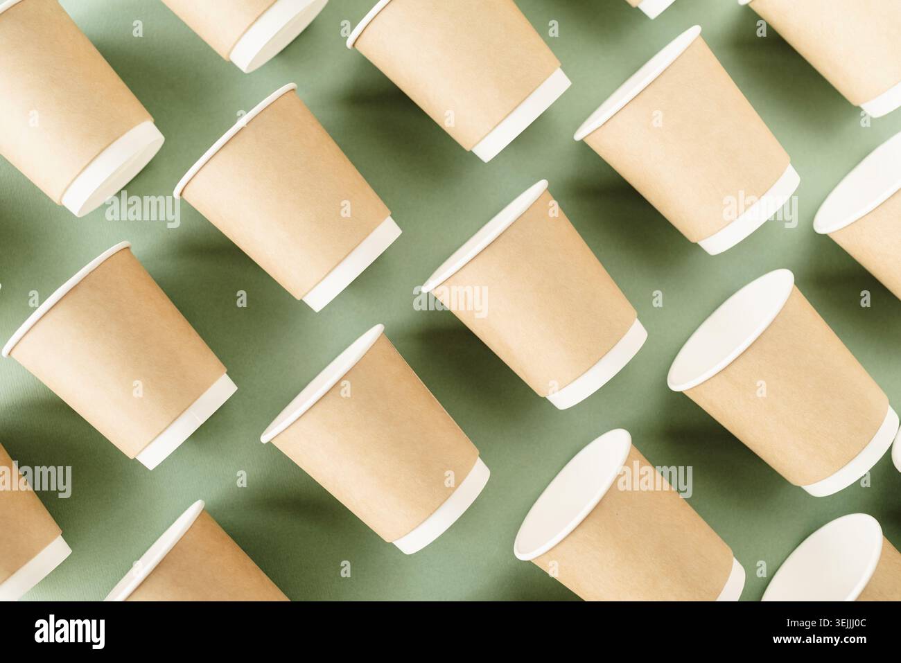 Disposable paper cups pattern top view on green background Stock Photo