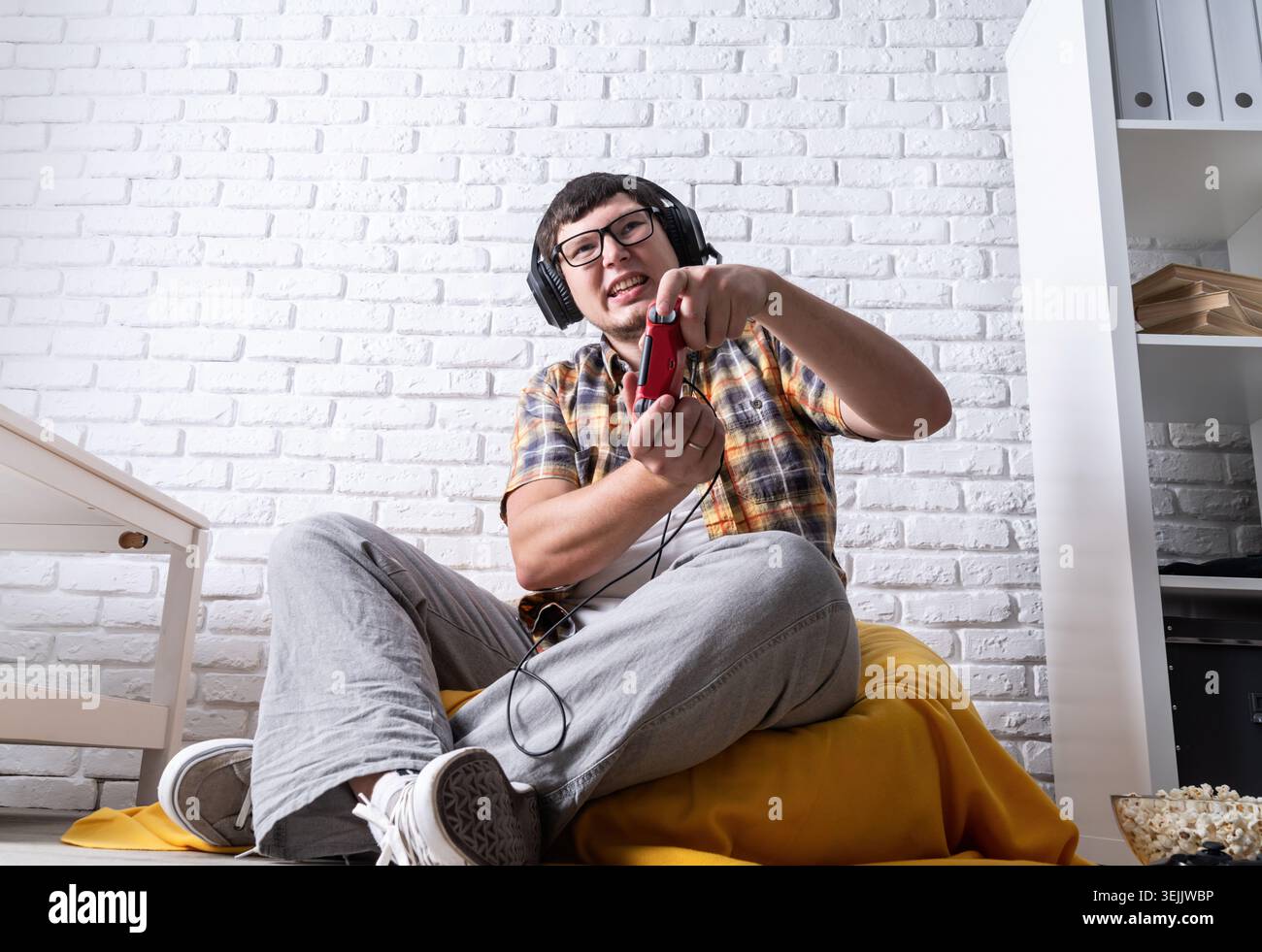 Young man playing video games at home Stock Photo