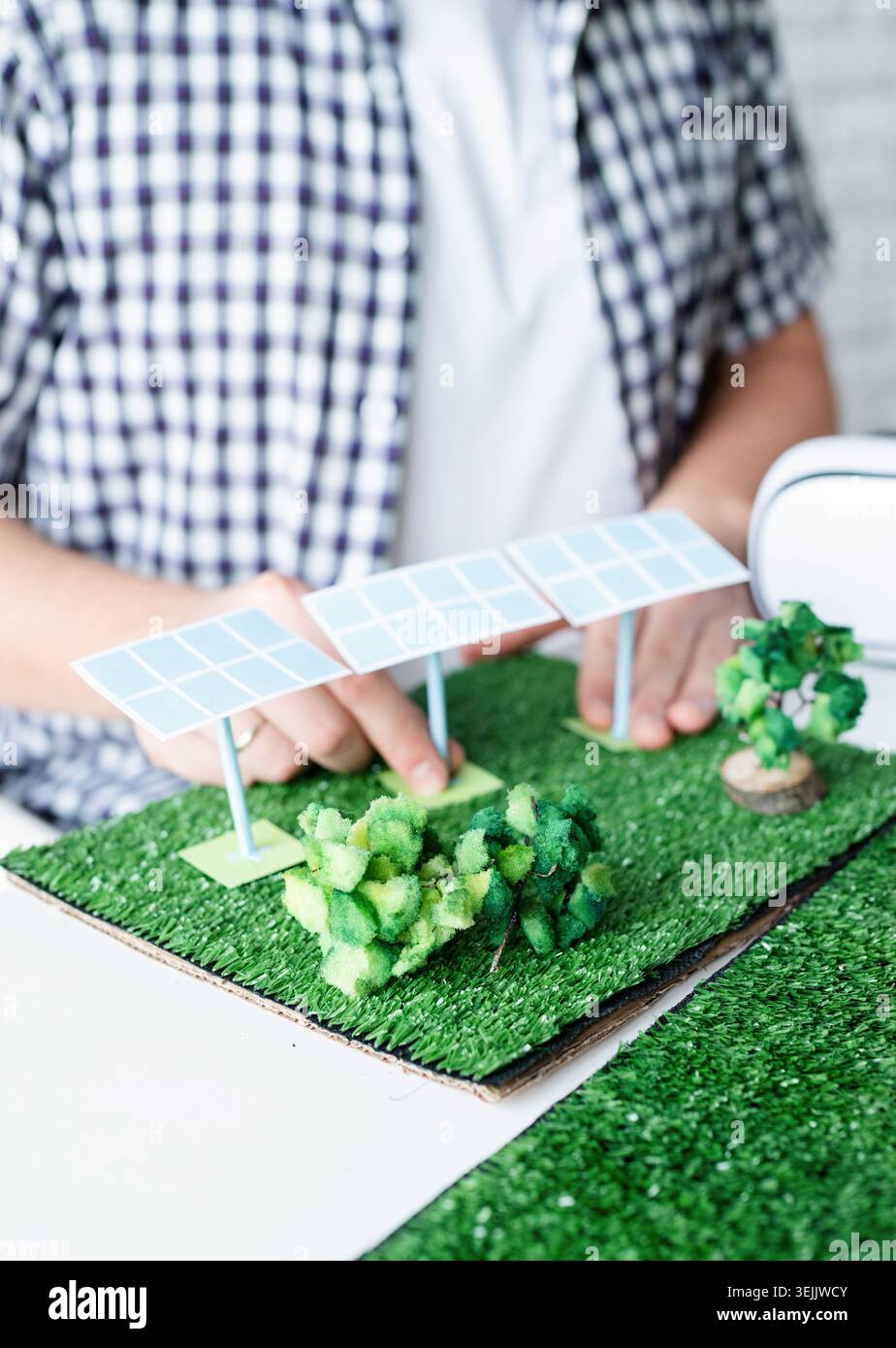 Young man making renewable energy project dummy Stock Photo