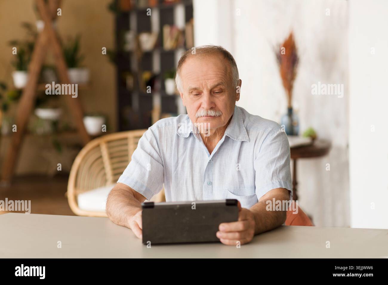 Elderly man using digital tablet  and Communicate online at home. Distancing. copy space. Stock Photo