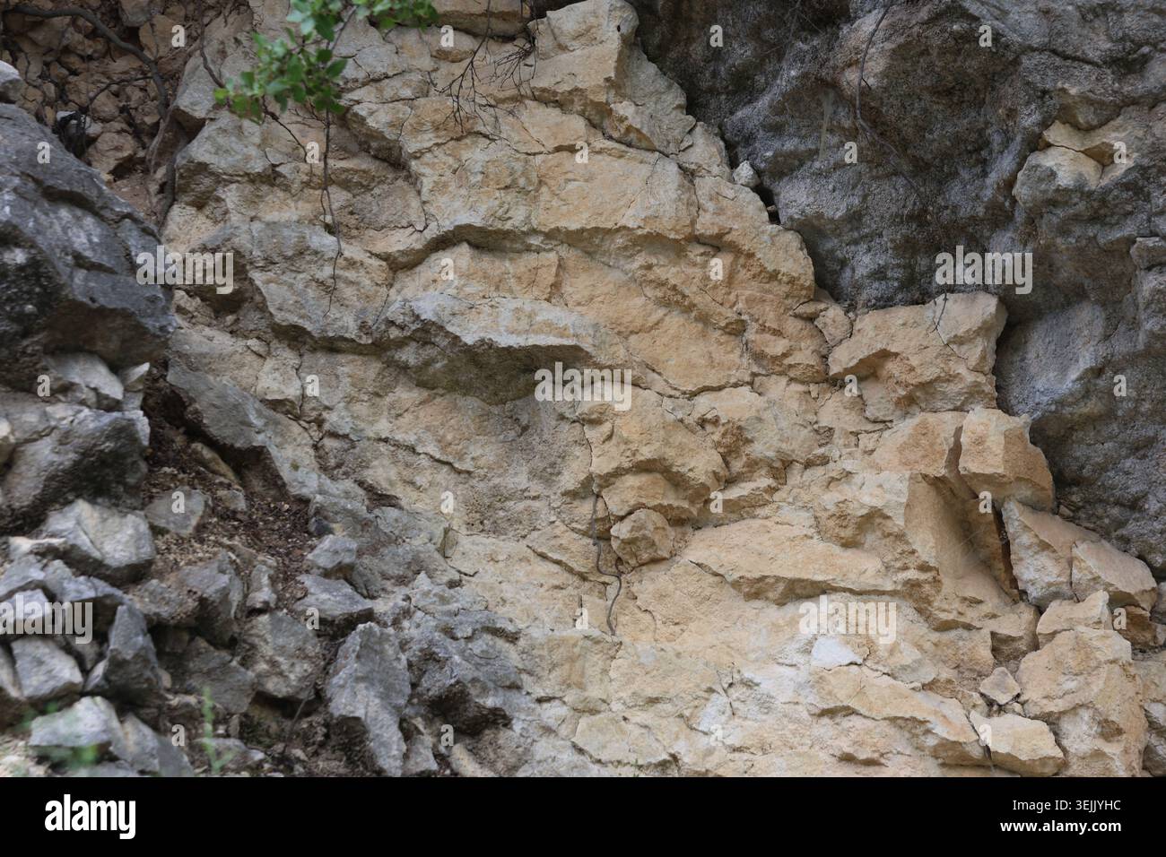 Natural Textured Limestone Rock Surface with Fractures and Angular Cracks Stock Photo