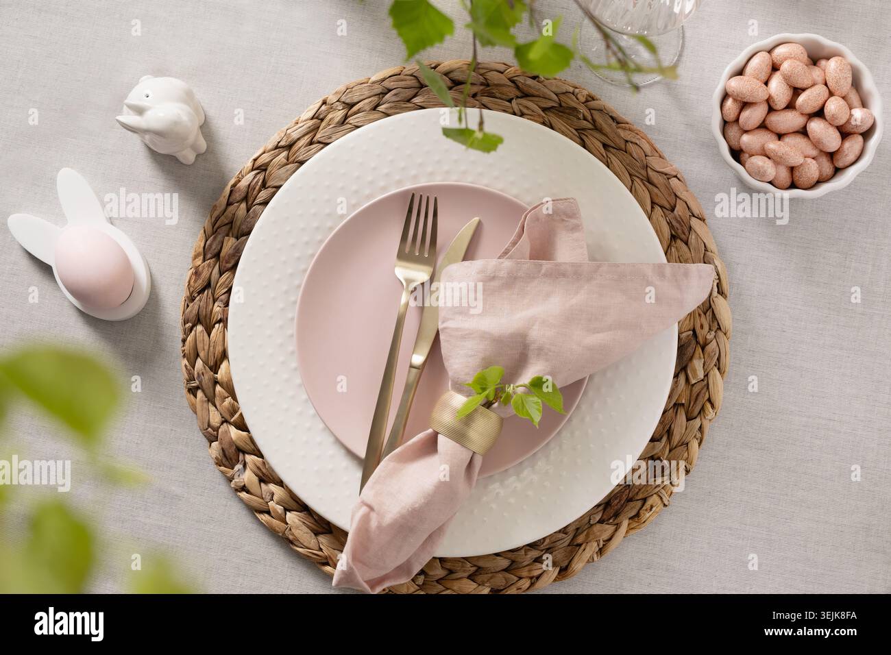 Easter table setting with pink plate and spring decor Stock Photo