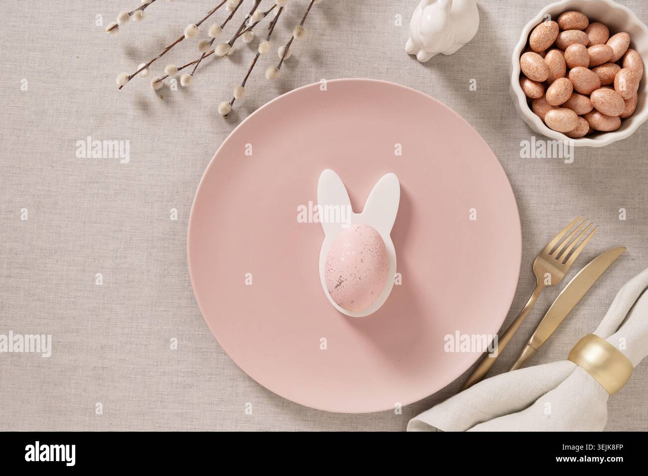 Minimal Easter table setting with empty plate and eggs Stock Photo