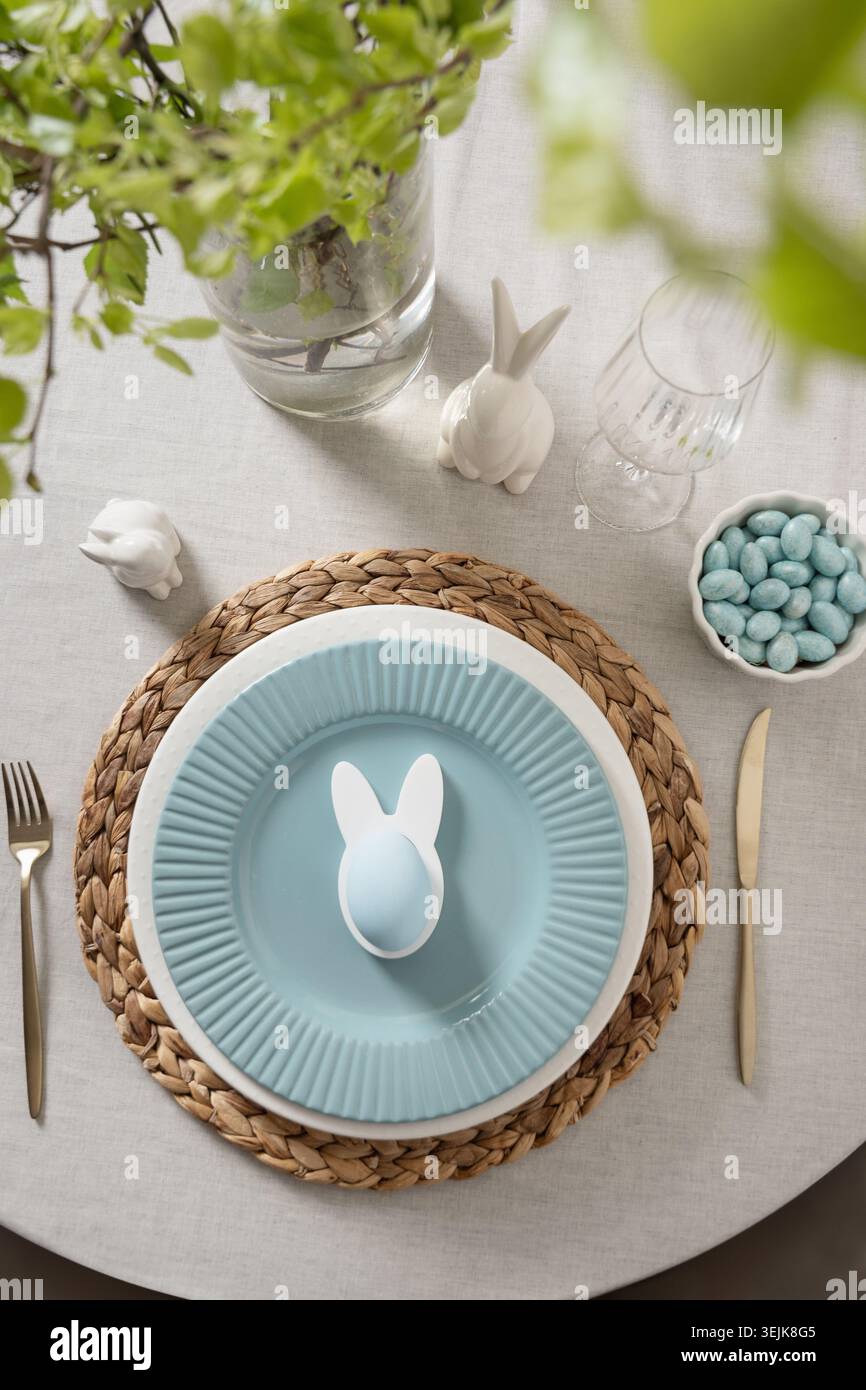 Easter table setting with bunny plate and pastel eggs Stock Photo