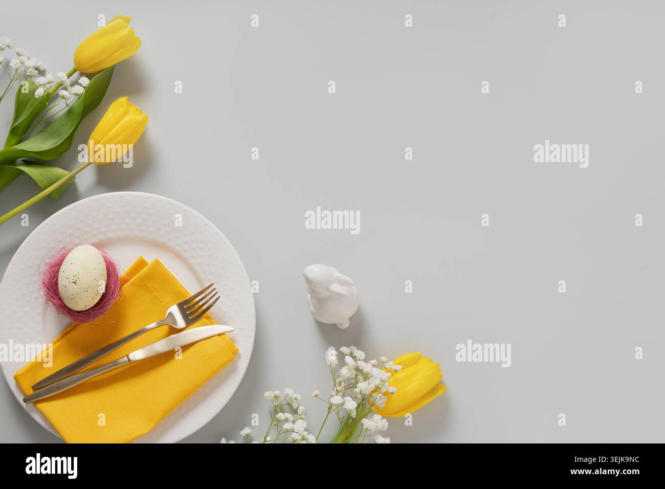 Easter plate with egg and spring flowers composition Stock Photo
