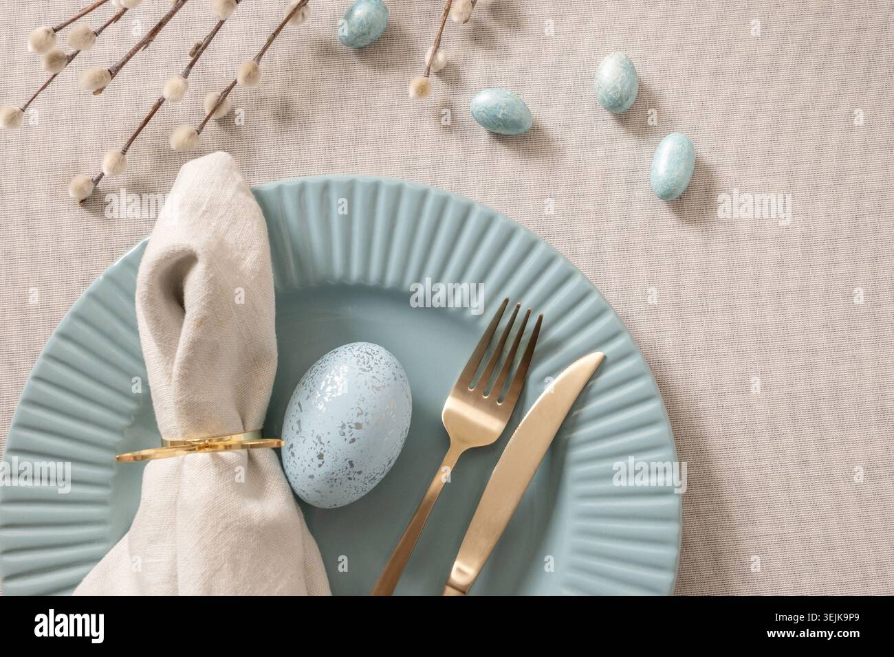 Minimal Easter table setting with blue ceramic plate Stock Photo