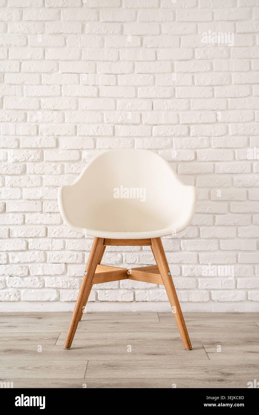 White chair on a brick wall background Stock Photo