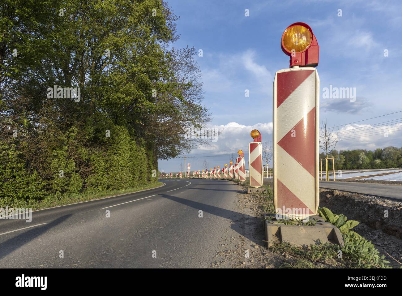 Yellow warning lights on a series of guide beacons photographed as an ...