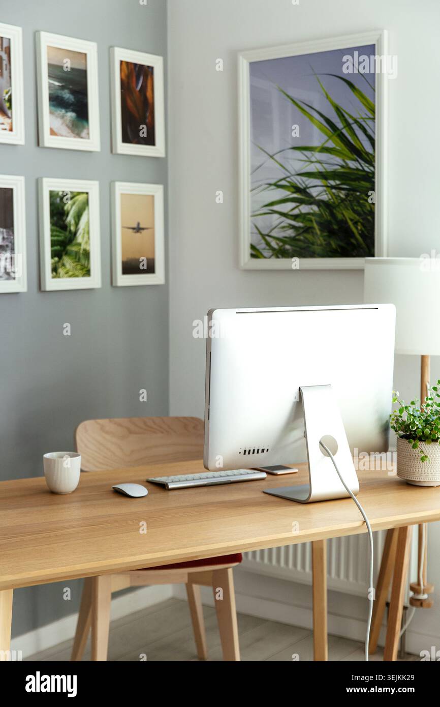 Work from home: cozy workplace for freelancer, programmer with computer, keyboard, mouse and plants Stock Photo
