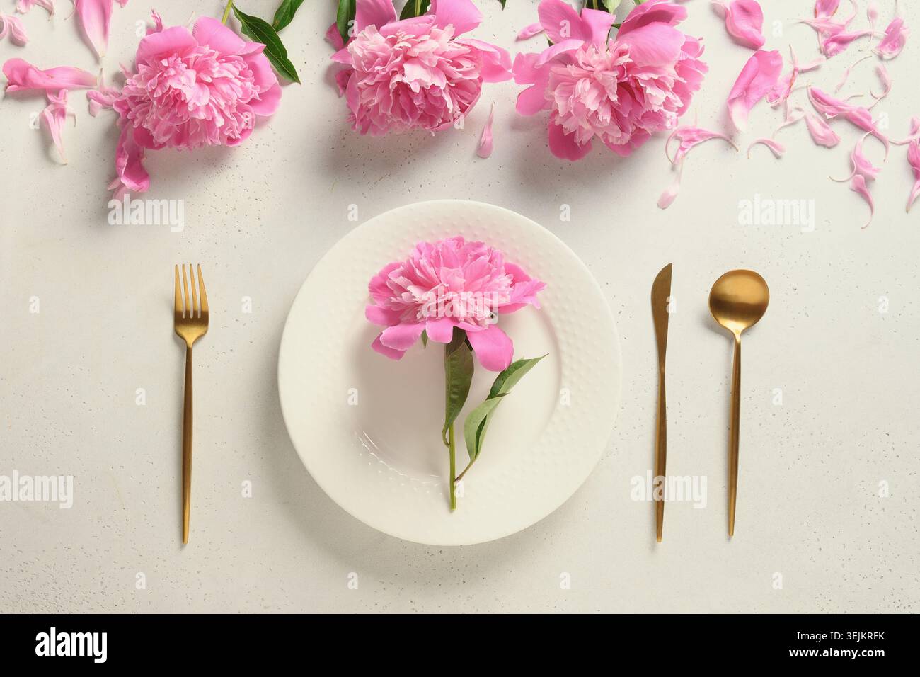 Elegance spring table setting with pink peony flowers. Stock Photo