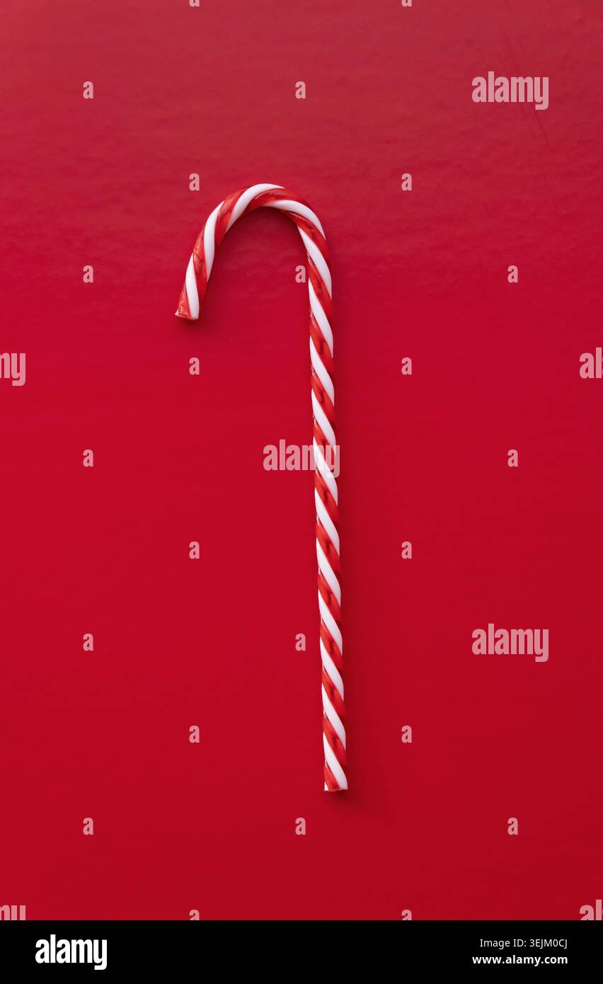 White and red candy cane isolated on red background Stock Photo