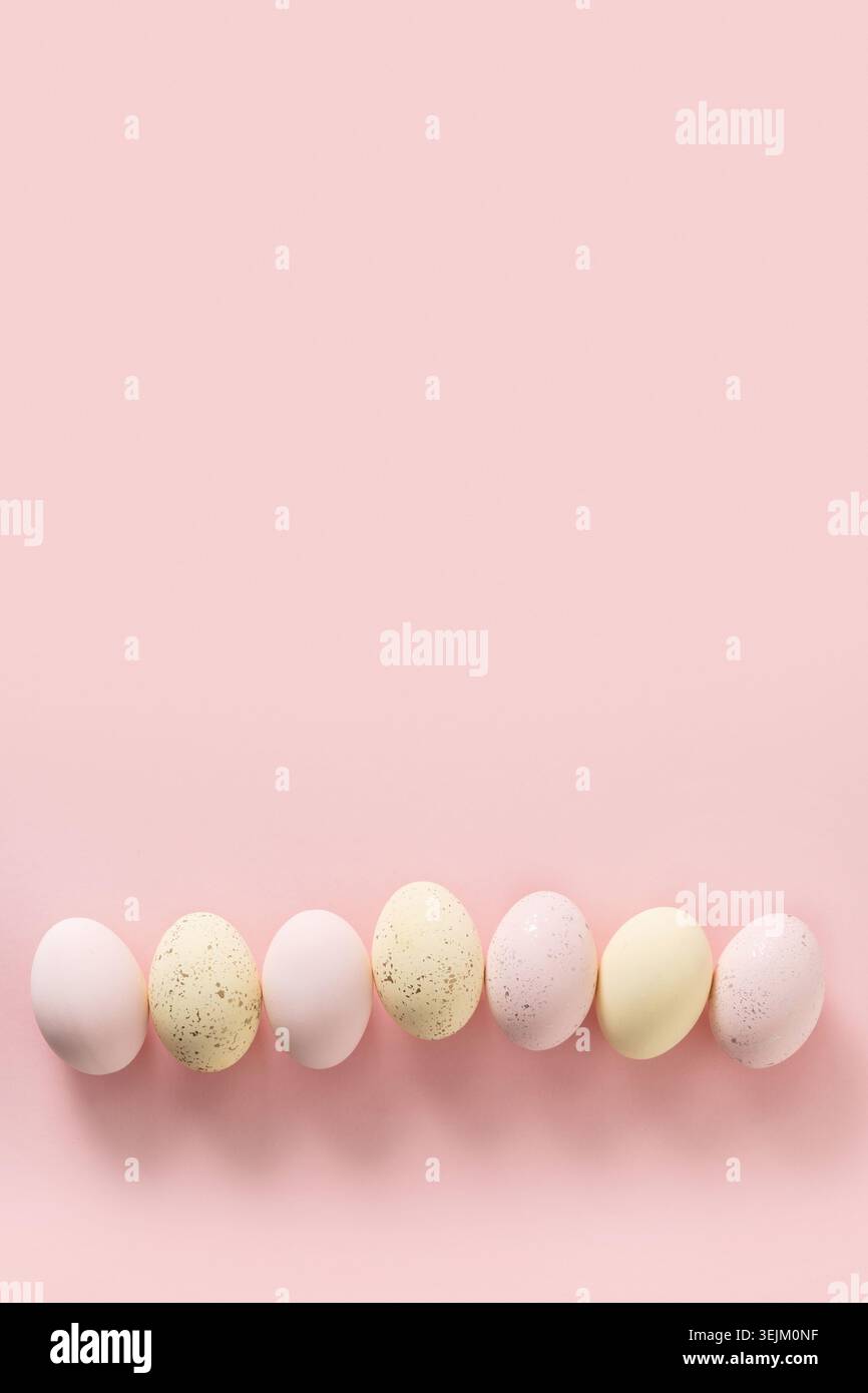 Easter pattern with pastel colorful eggs on pink background. Stock Photo
