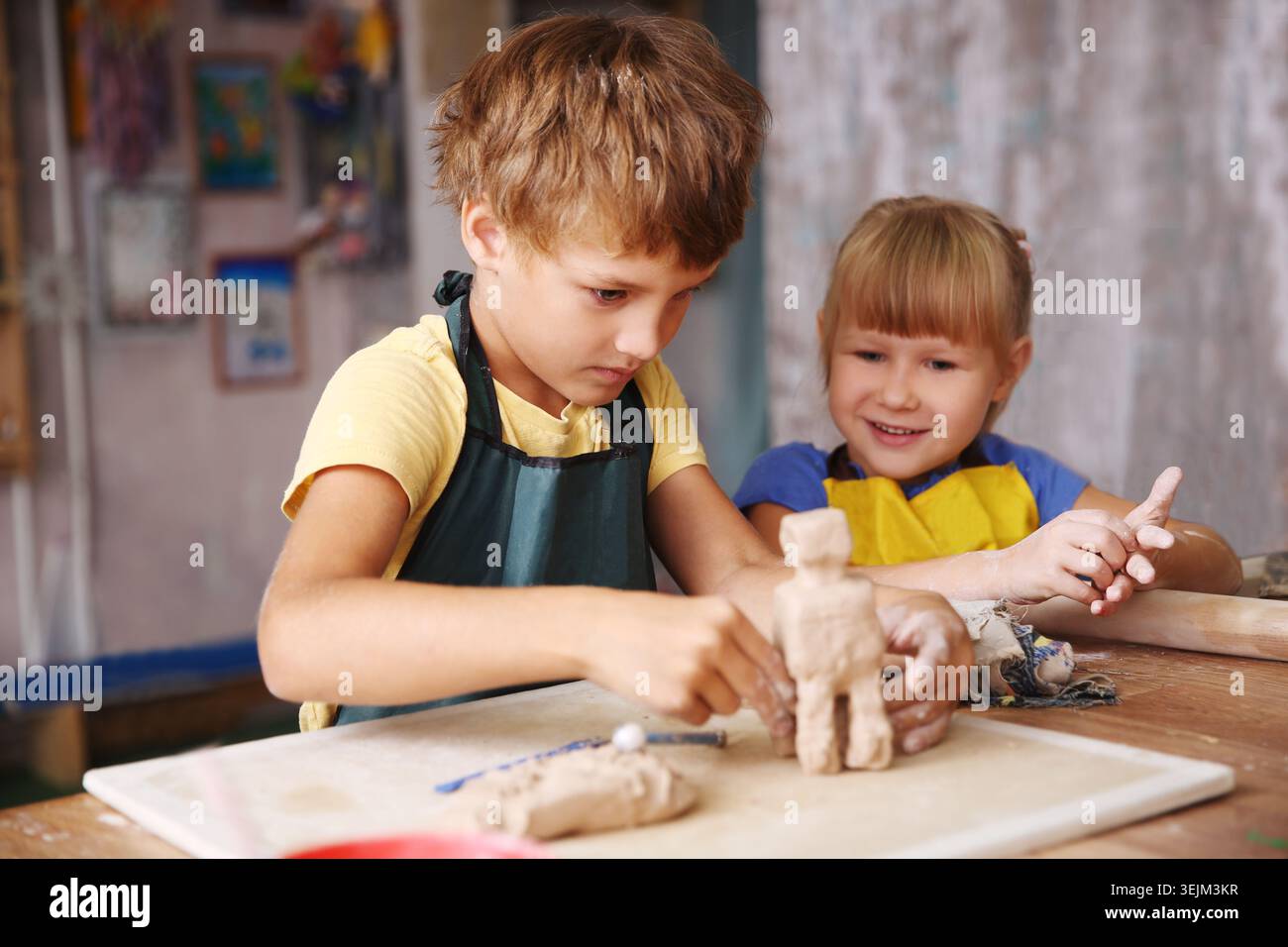 Kids molded from clay at pottery class. Stock Photo