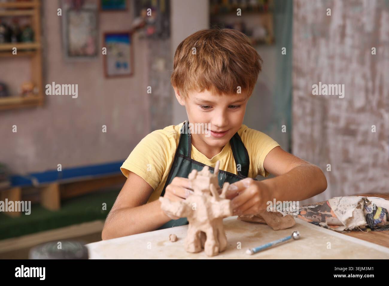 Kids molded from clay at pottery class. Stock Photo