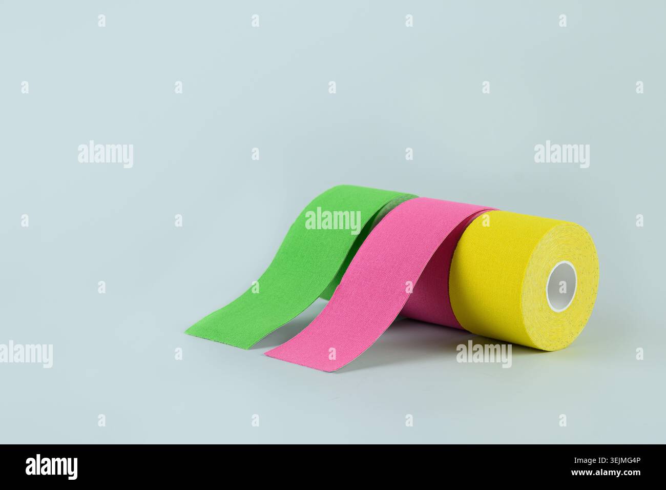 Three rolls kinesiology tape on blue background. Stock Photo
