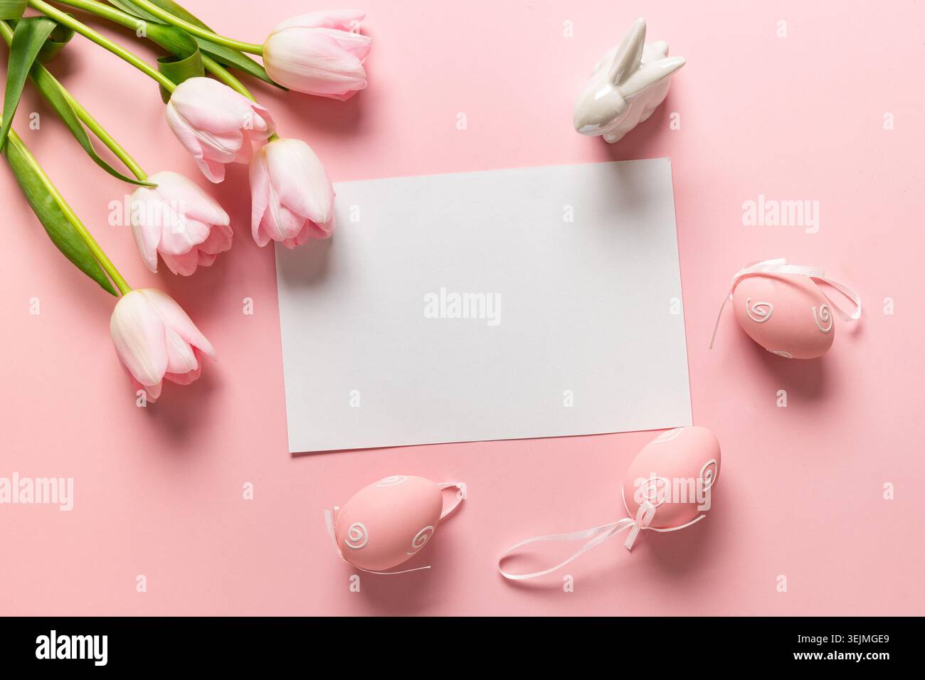 Easter frame with eggs, pink tulips on pink. Stock Photo