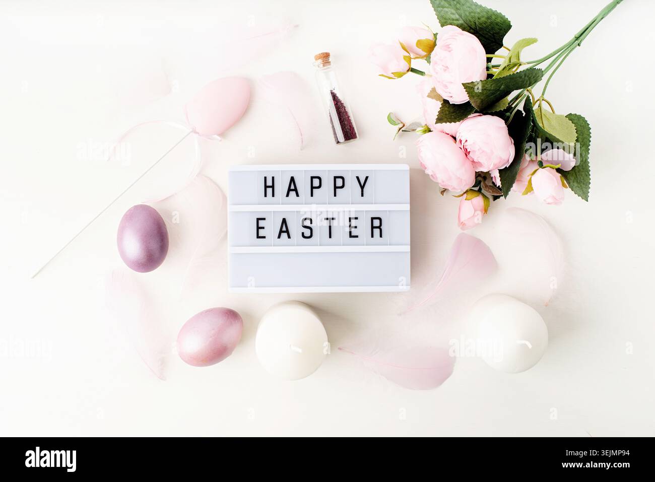 Top view Happy Easter light box decorated with pastel colored eggs and feathers Stock Photo