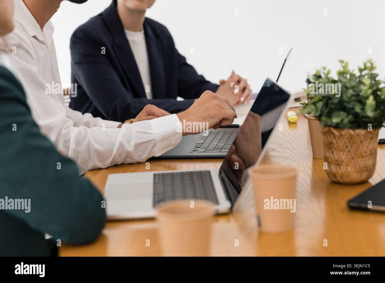 Business professionals collaborating at office meeting table Stock Photo
