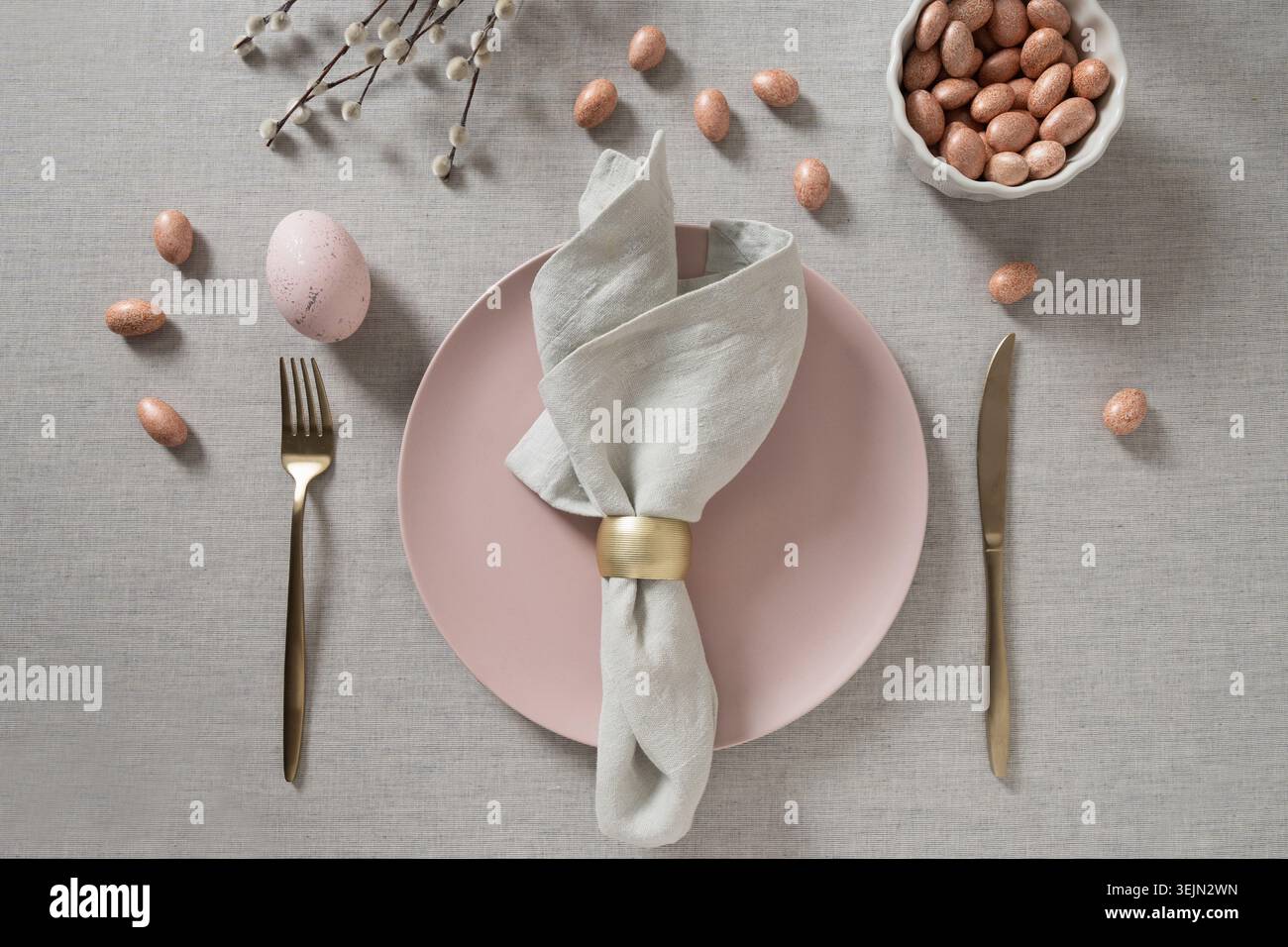 Easter table setting with pink egg and willow branches Stock Photo