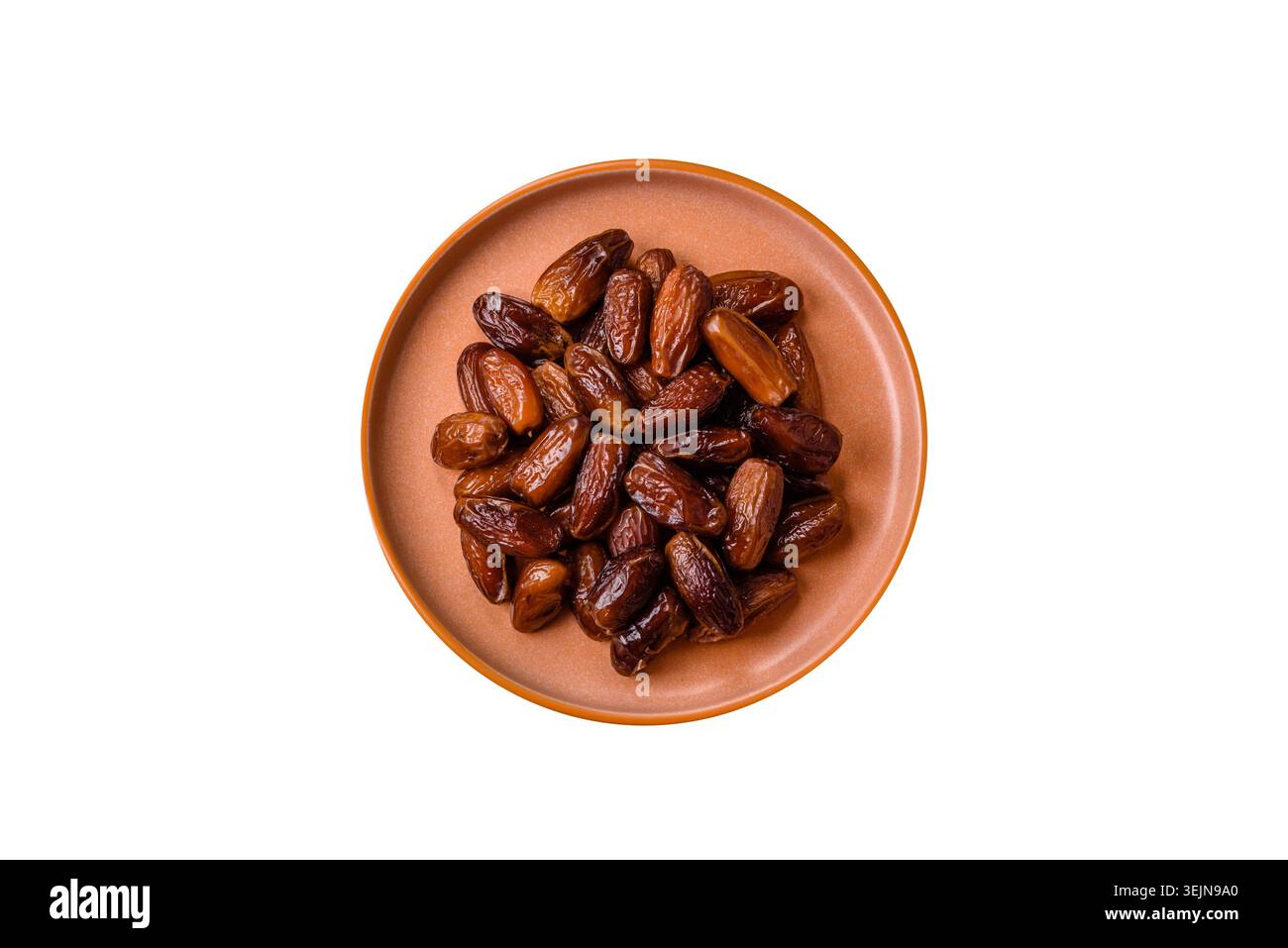 Dried dates on a ceramic plate for Ramadan or Iftar. Dates fruit as a background Stock Photo