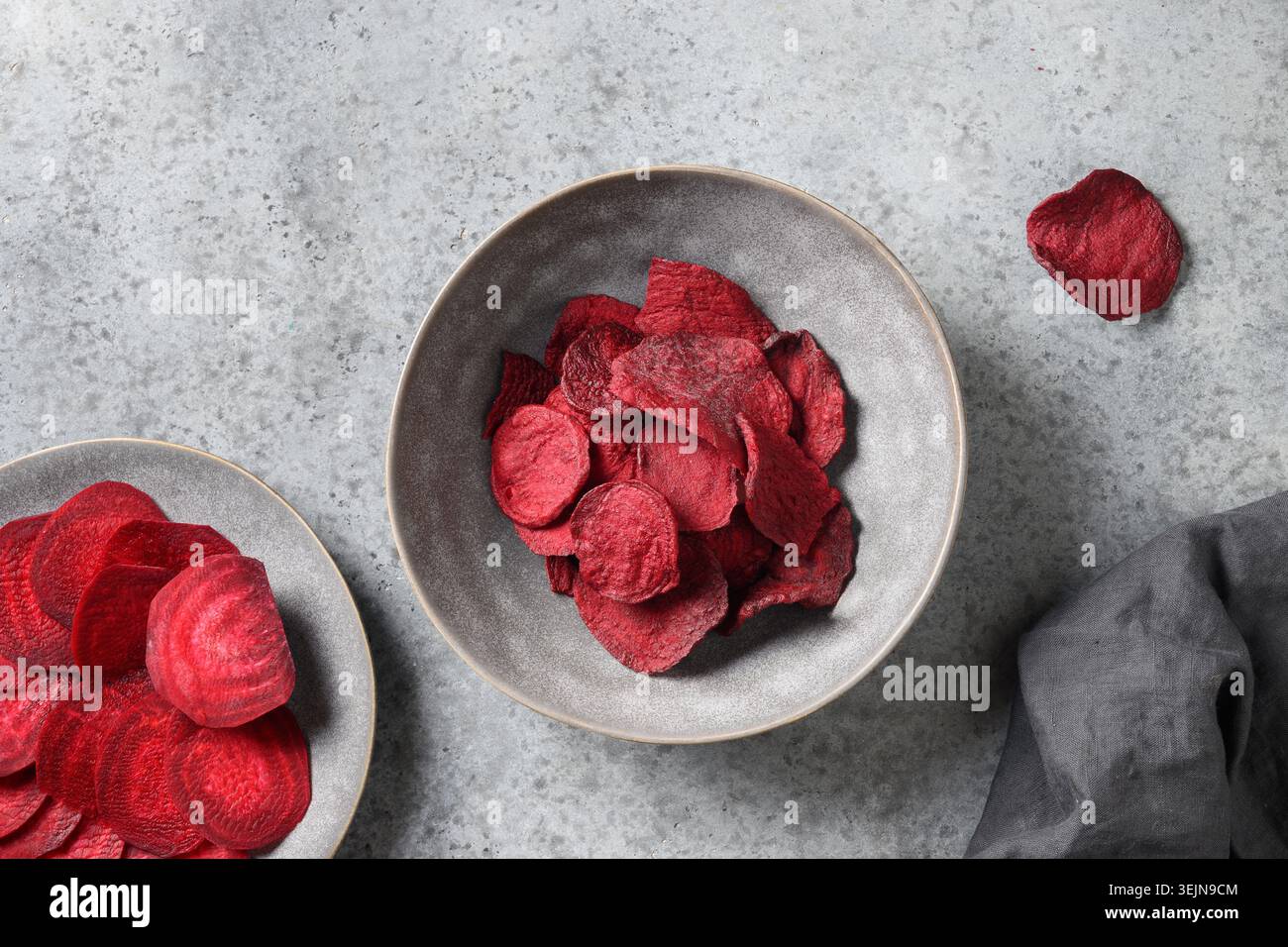 Vegetable beetroot chips in gray bowl on a white background. Stock Photo