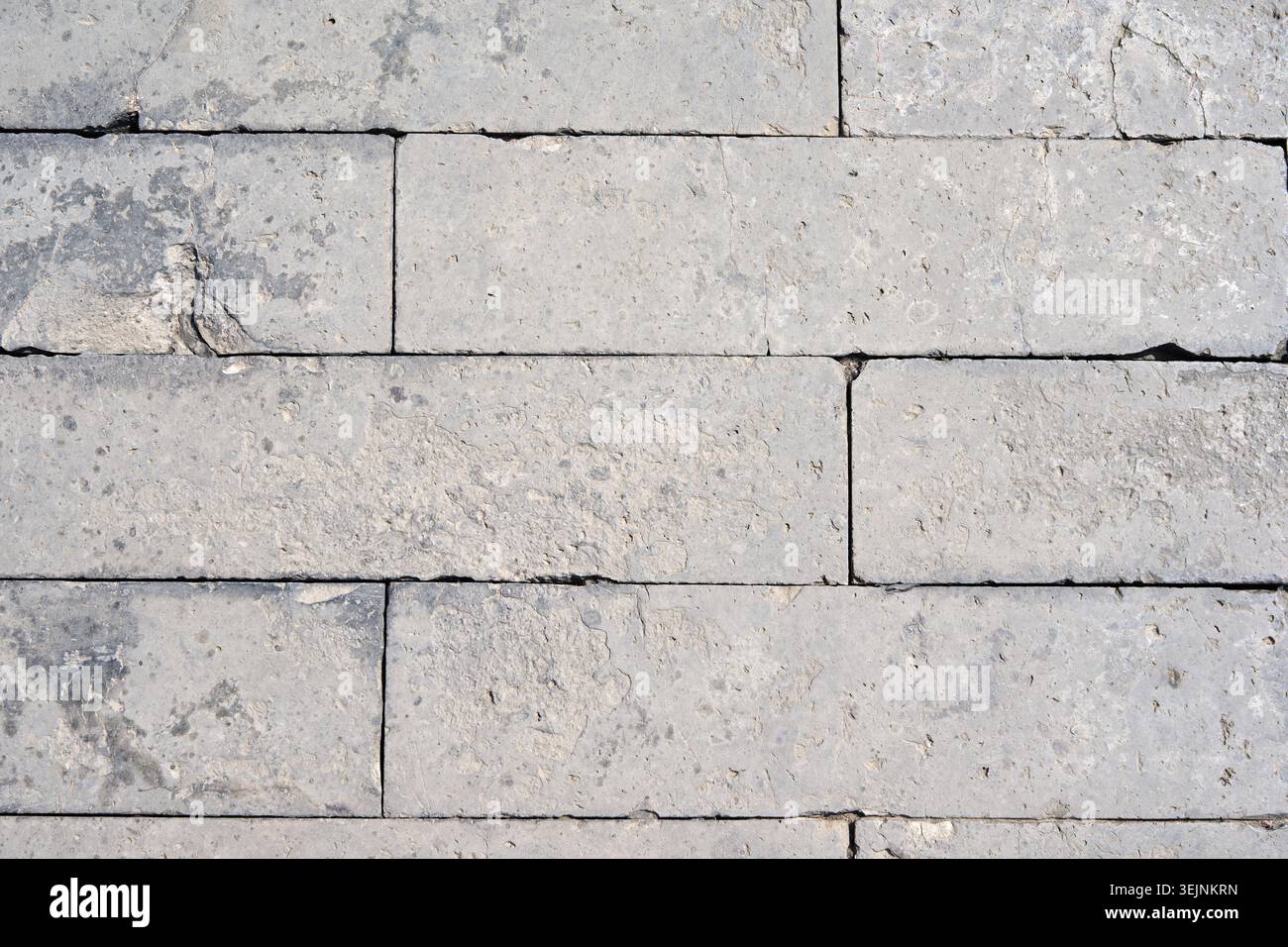 Light Gray Limestone Brick Wall Background with Natural Stone Texture. Stock Photo