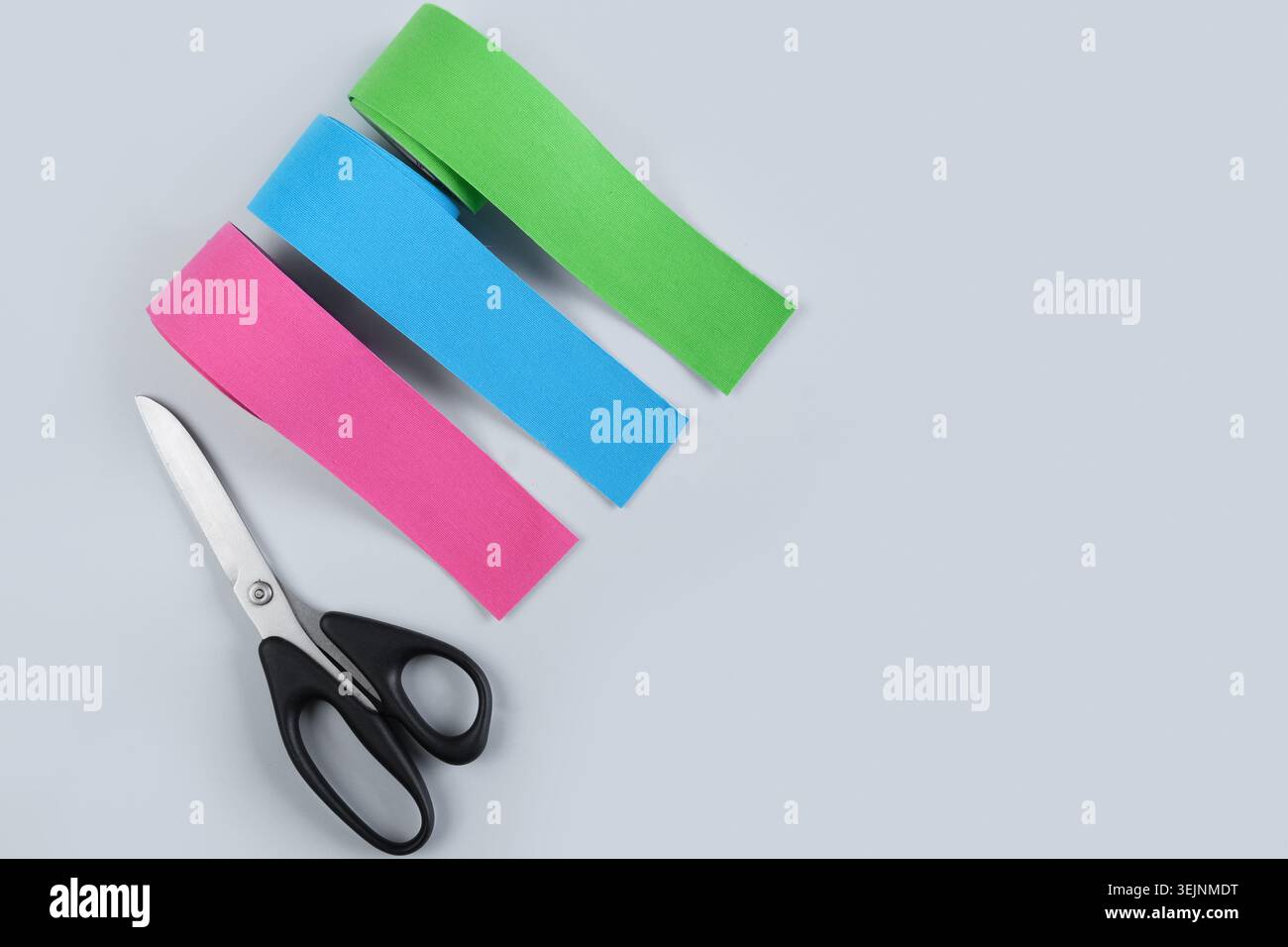 Three rolls kinesiology tape on blue background. Stock Photo