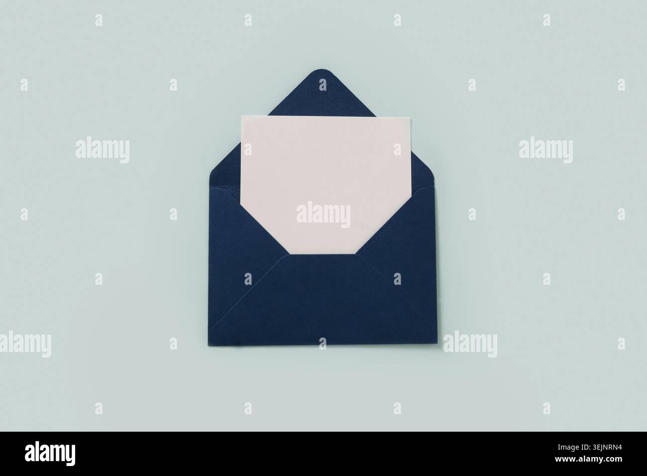 Blue paper envelope on blue background. View from above. Stock Photo