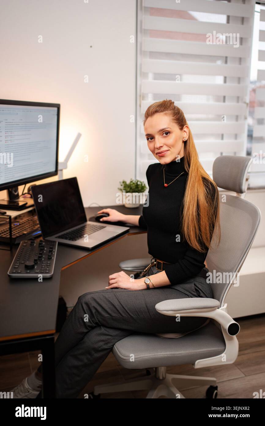 Woman programmer working on computer in modern office Stock Photo