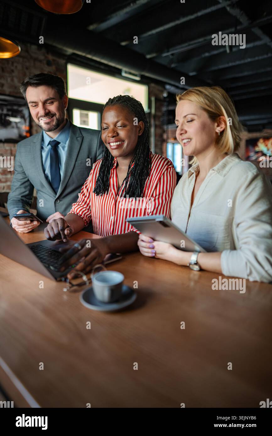 Diverse business professionals smiling, collaborating and working together Stock Photo