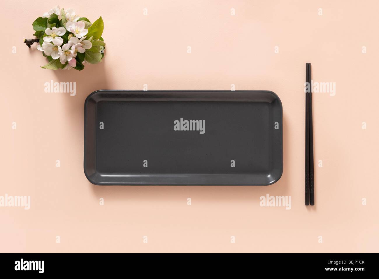 Empty rectangular plate with chopsticks and spring branches decoration Stock Photo