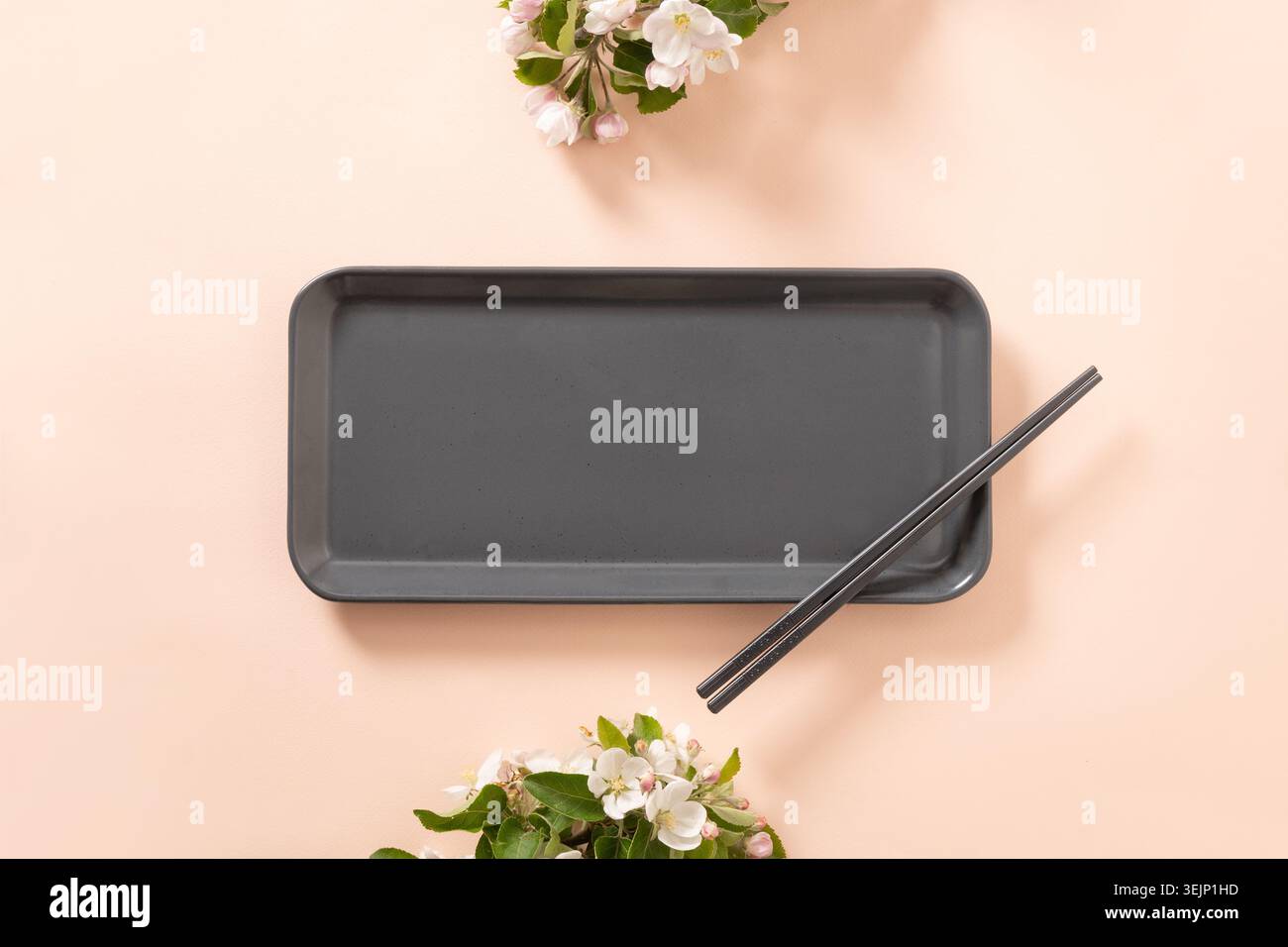 Empty rectangular plate with chopsticks and spring branches decoration Stock Photo