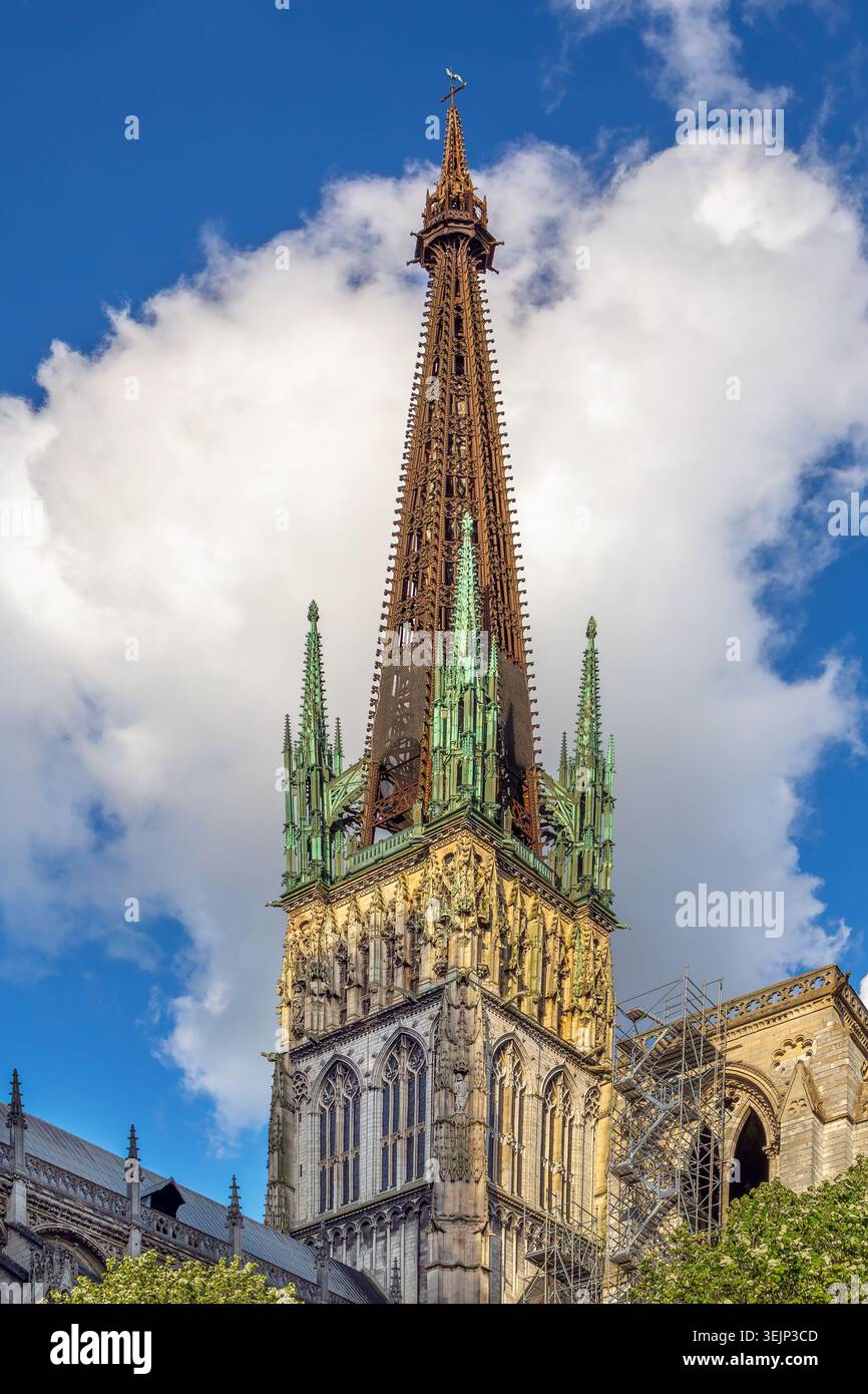 Rouen Cathedral, France, low angle view of main tower. High gothic stone architecture under partly cloudy daylight sky Stock Photo