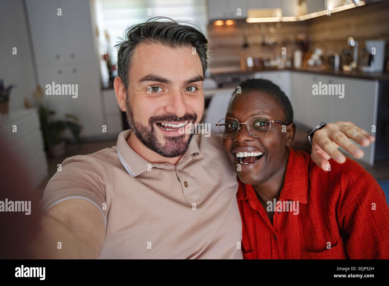 Happy couple taking a selfie at home Stock Photo
