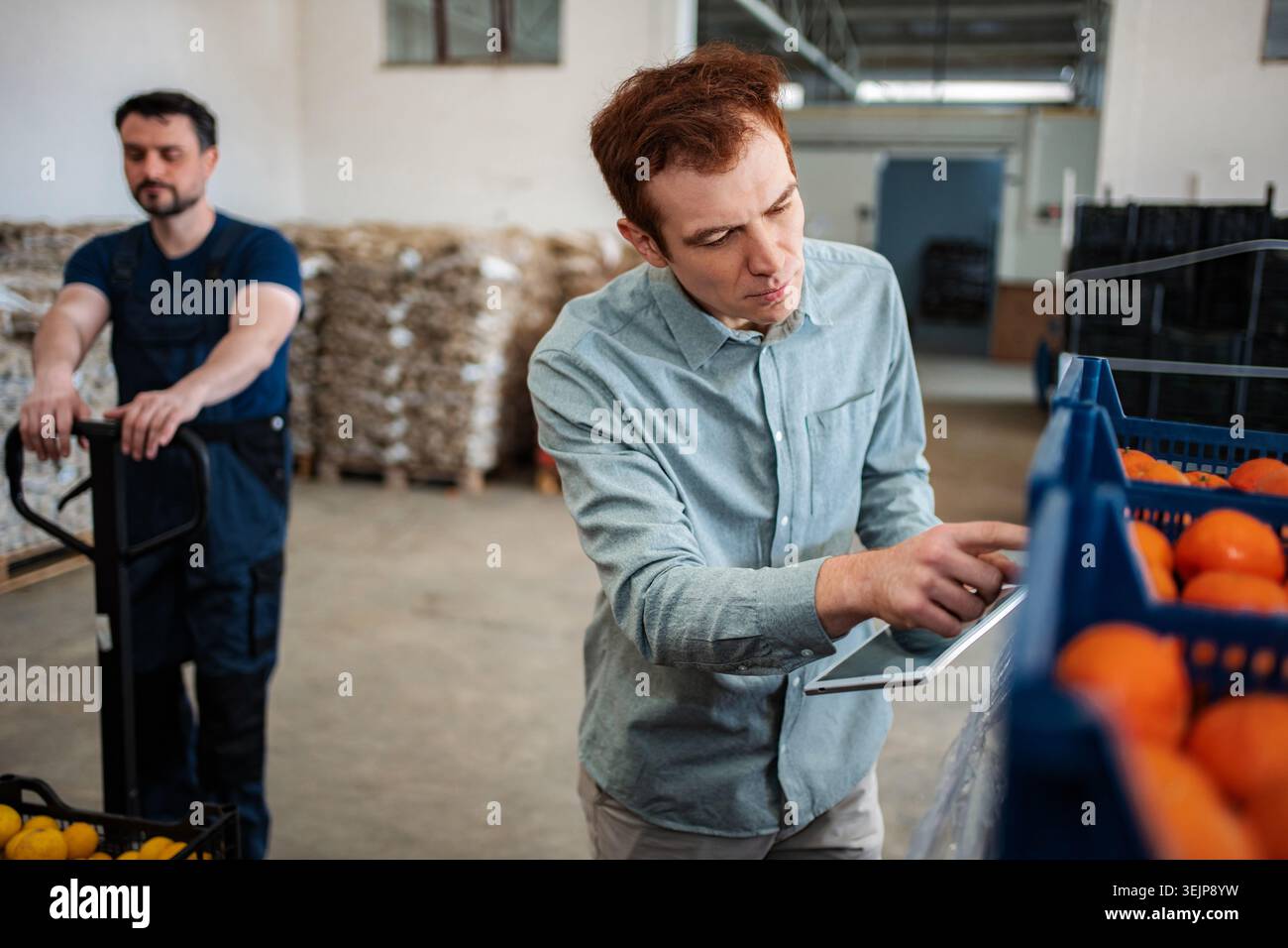 Quality control manager using digital tablet checking freshness Stock Photo