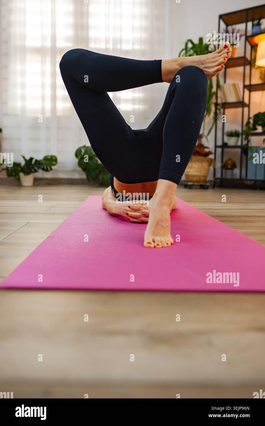 Practicing advanced yoga poses in a serene indoor environment Stock Photo