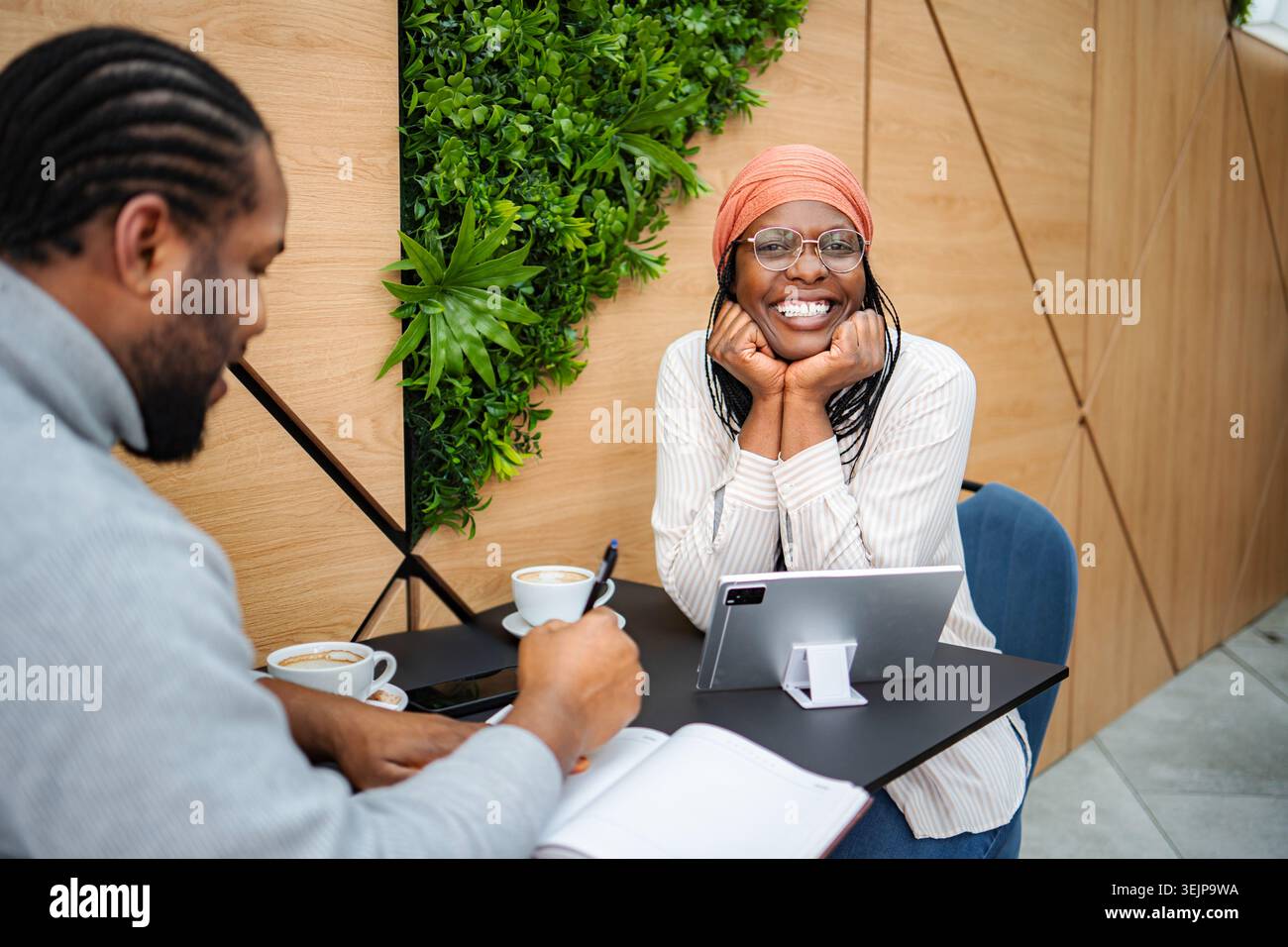 Diverse business professionals having a coffee shop meeting Stock Photo