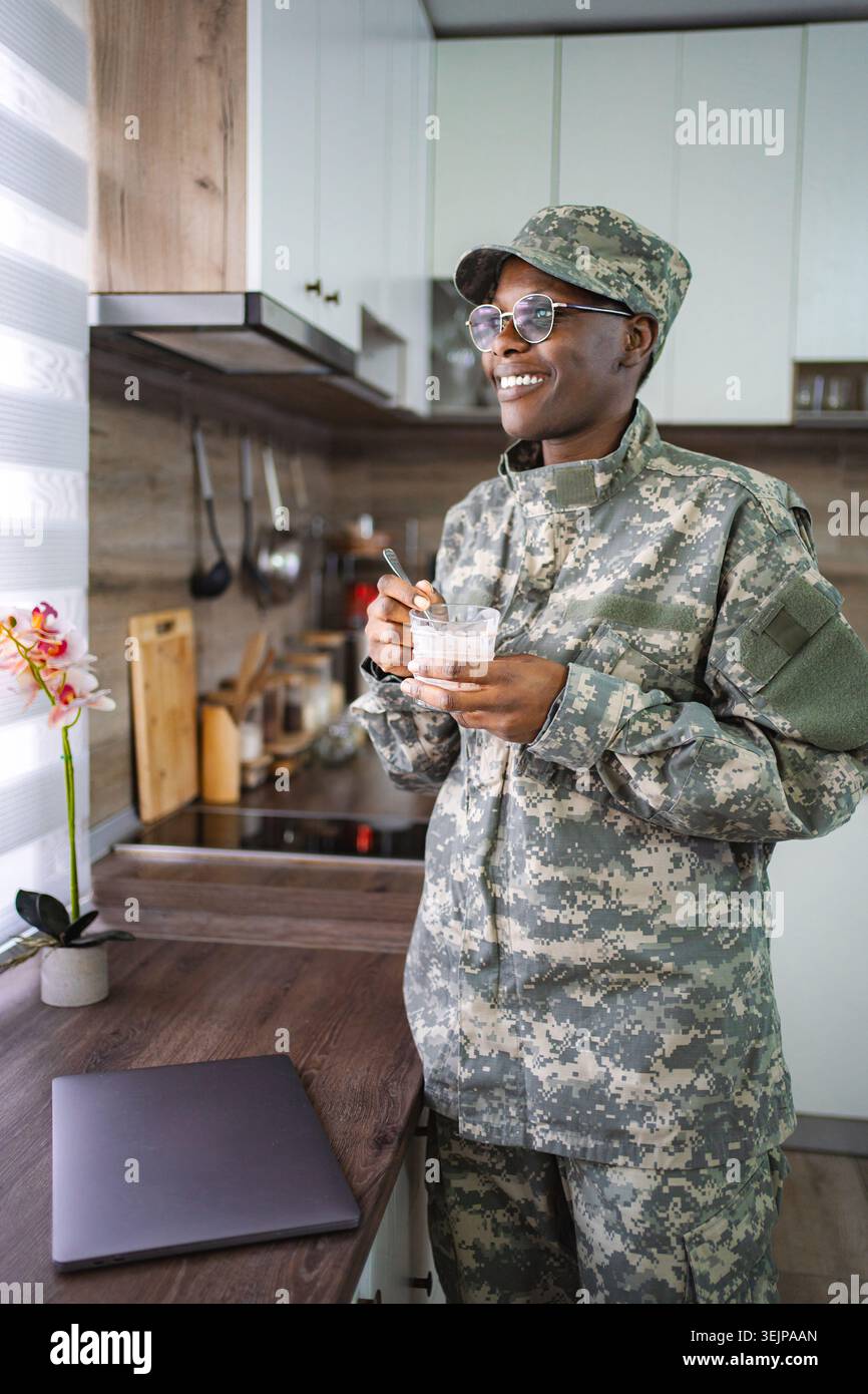 Smiling african american soldier enjoying breakfast in kitchen Stock Photo