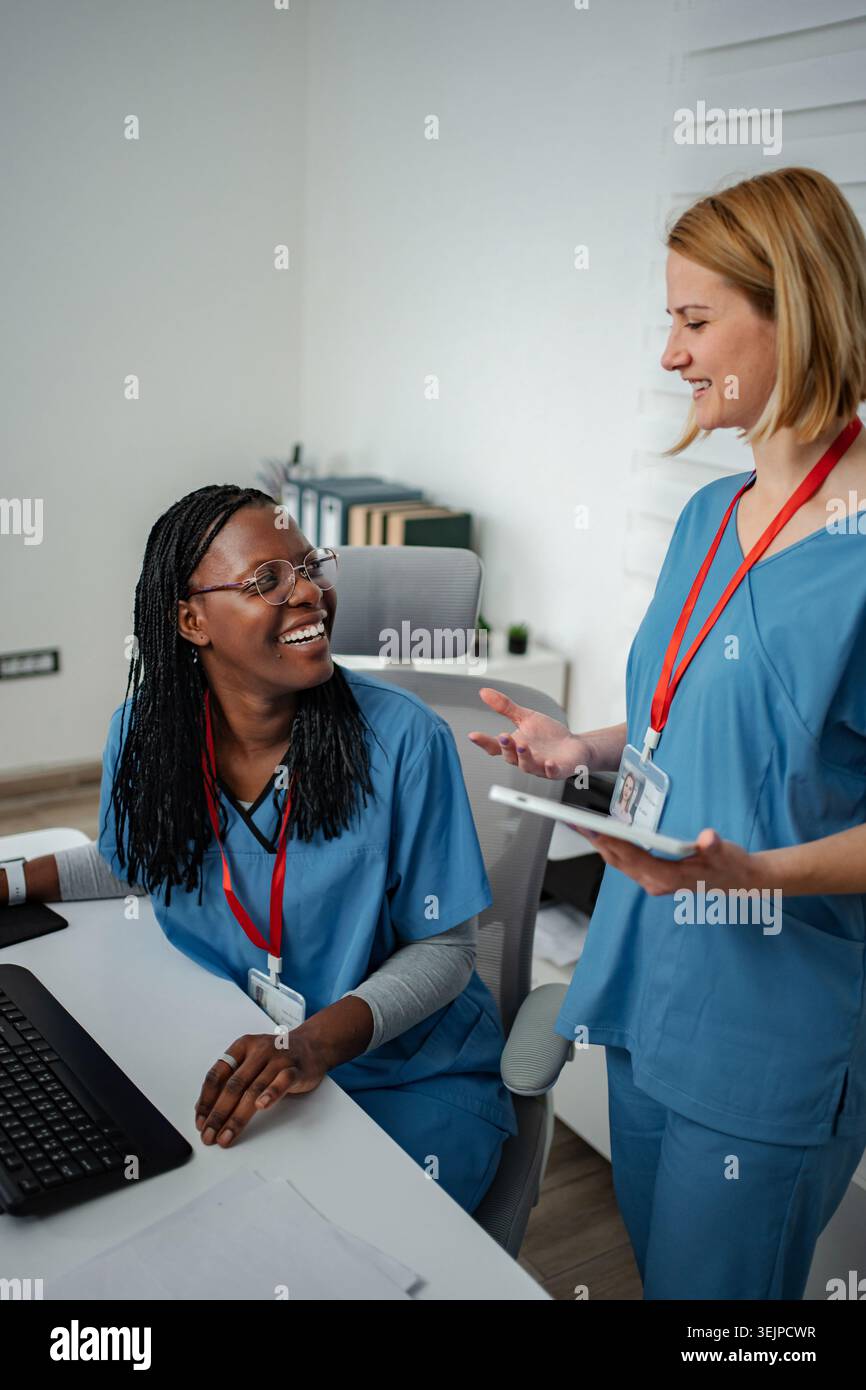 Two nurses discussing patient information using a digital tablet Stock Photo
