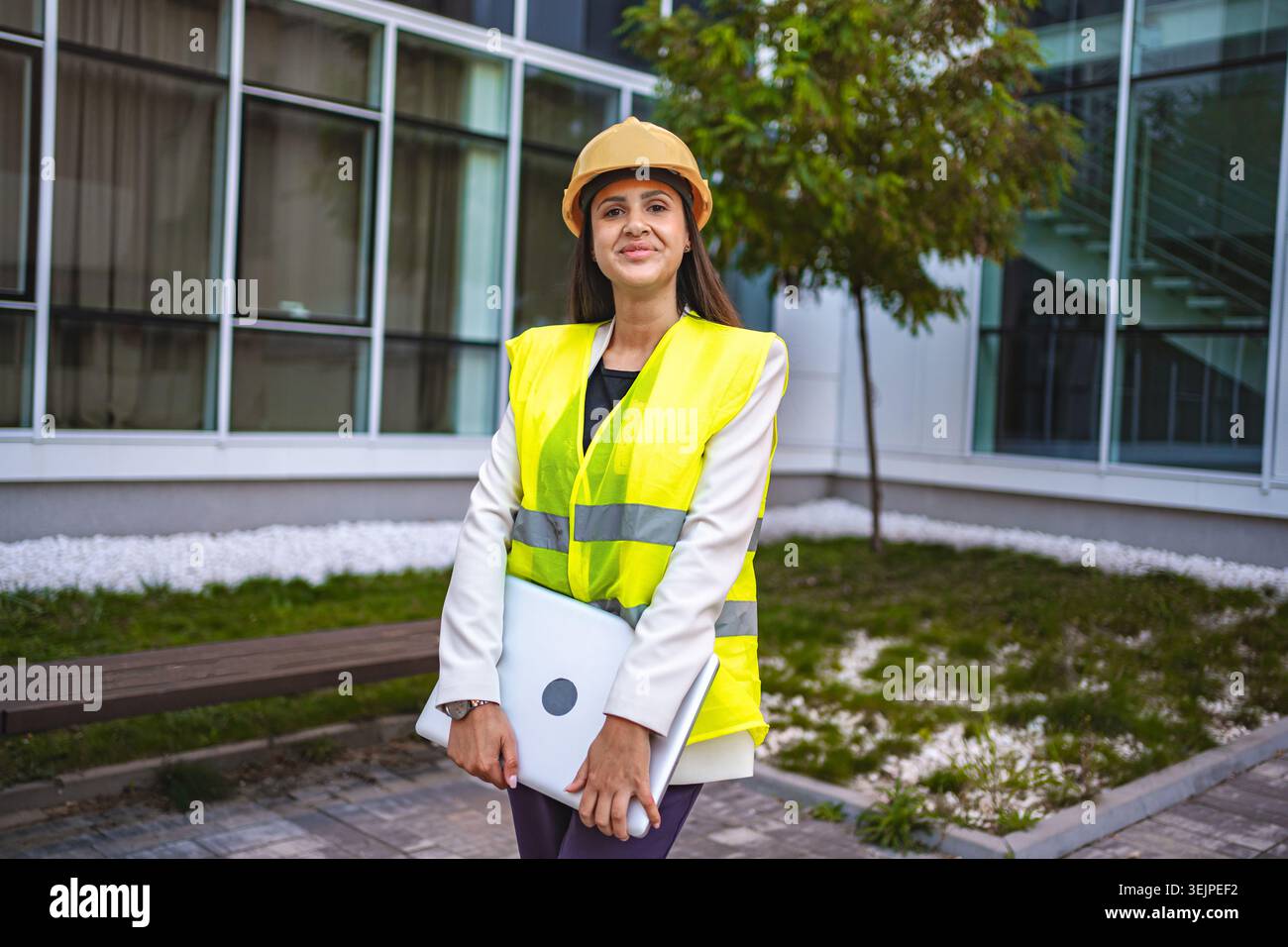 Smiling female safety engineer outdoors Stock Photo