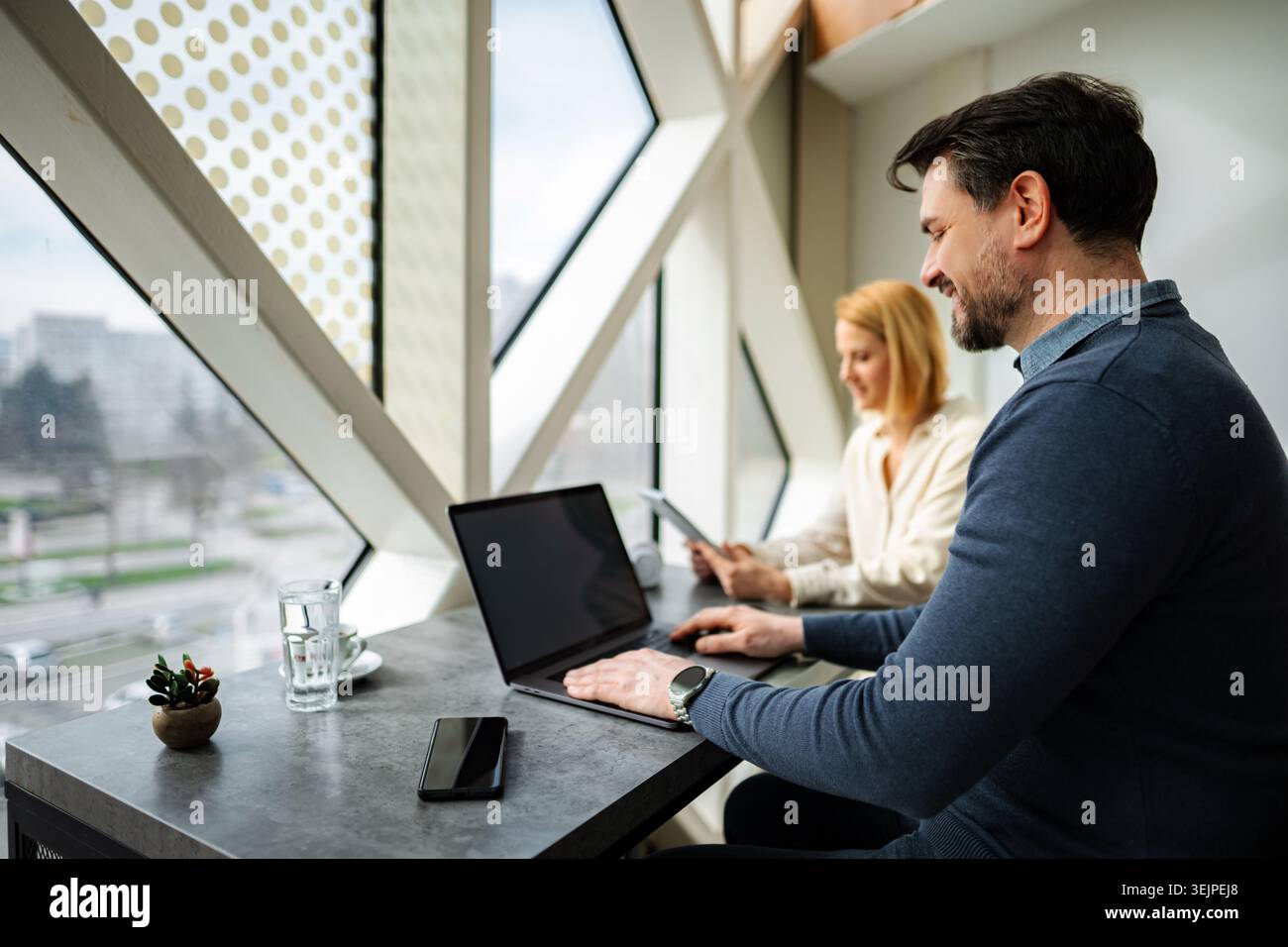 Professional people working using laptops in modern office Stock Photo