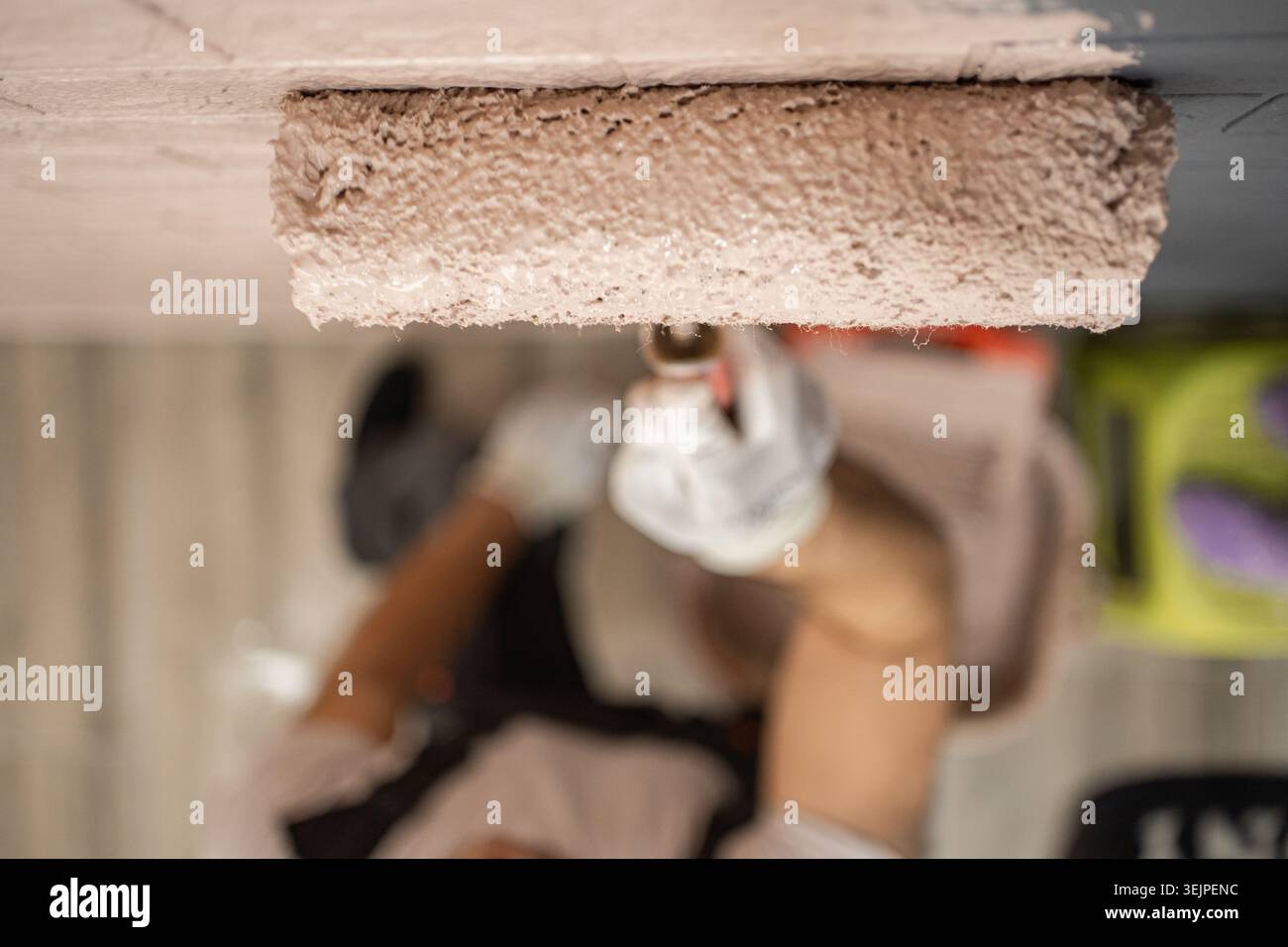 Roller with paint on the wall Stock Photo