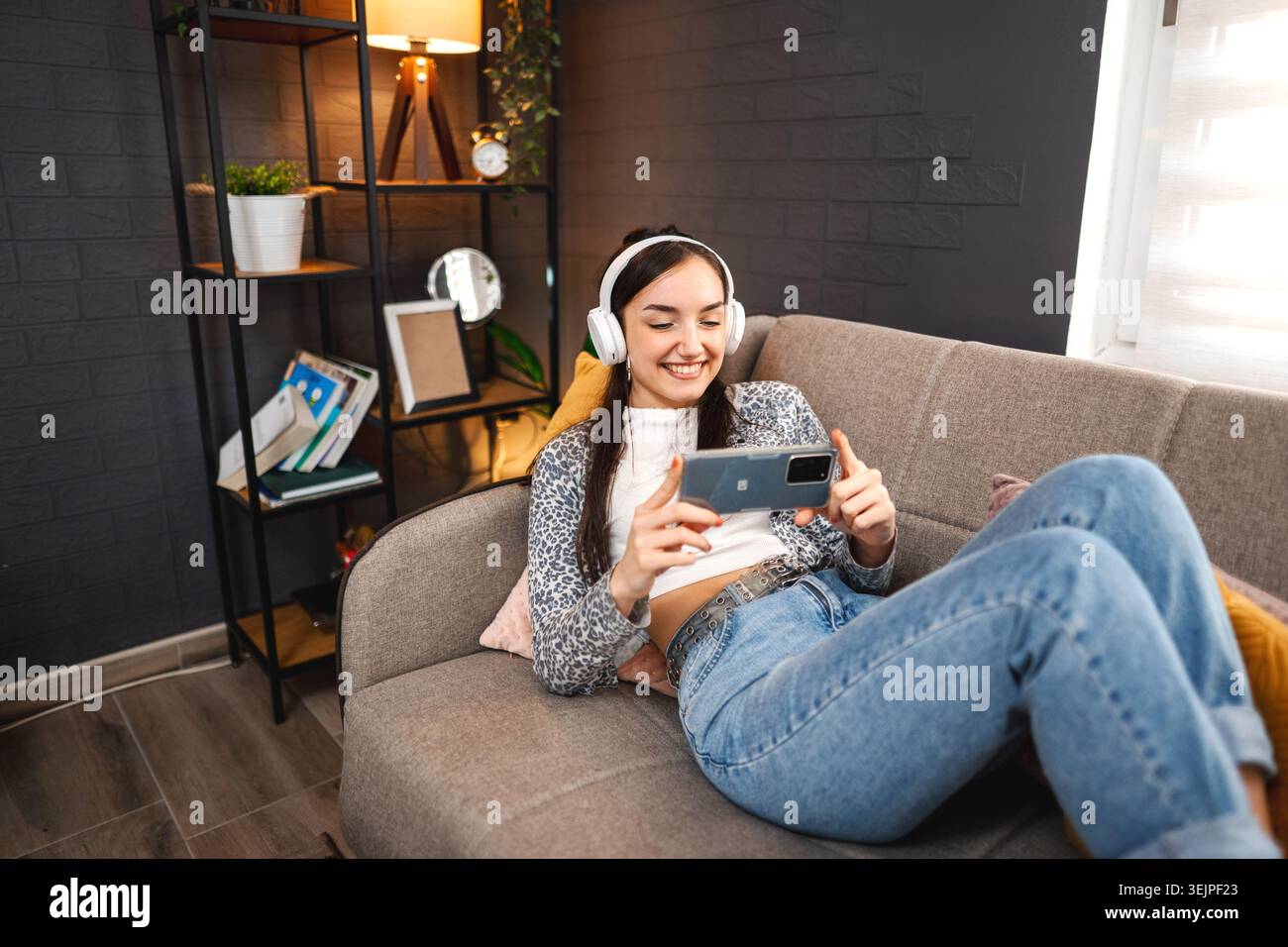 Relaxed young woman using mobile phone Stock Photo