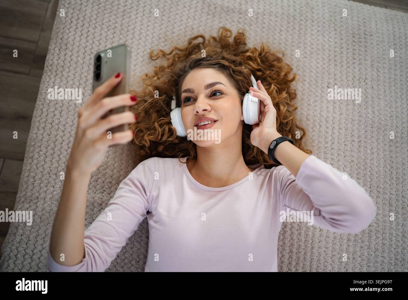 Young woman enjoying music and video calling with smartphone Stock Photo