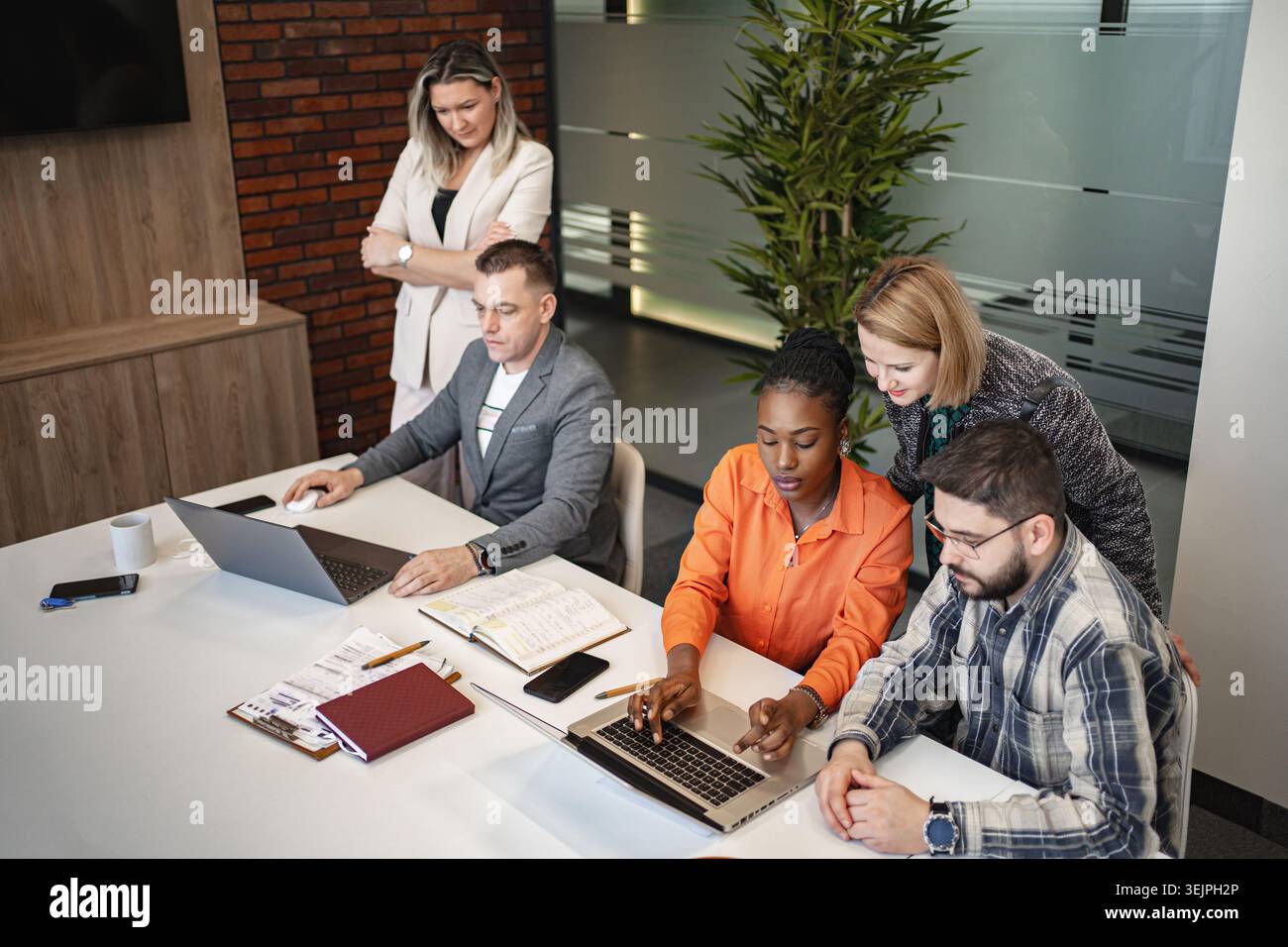 Team of Professionals Collaborating on Laptops Stock Photo