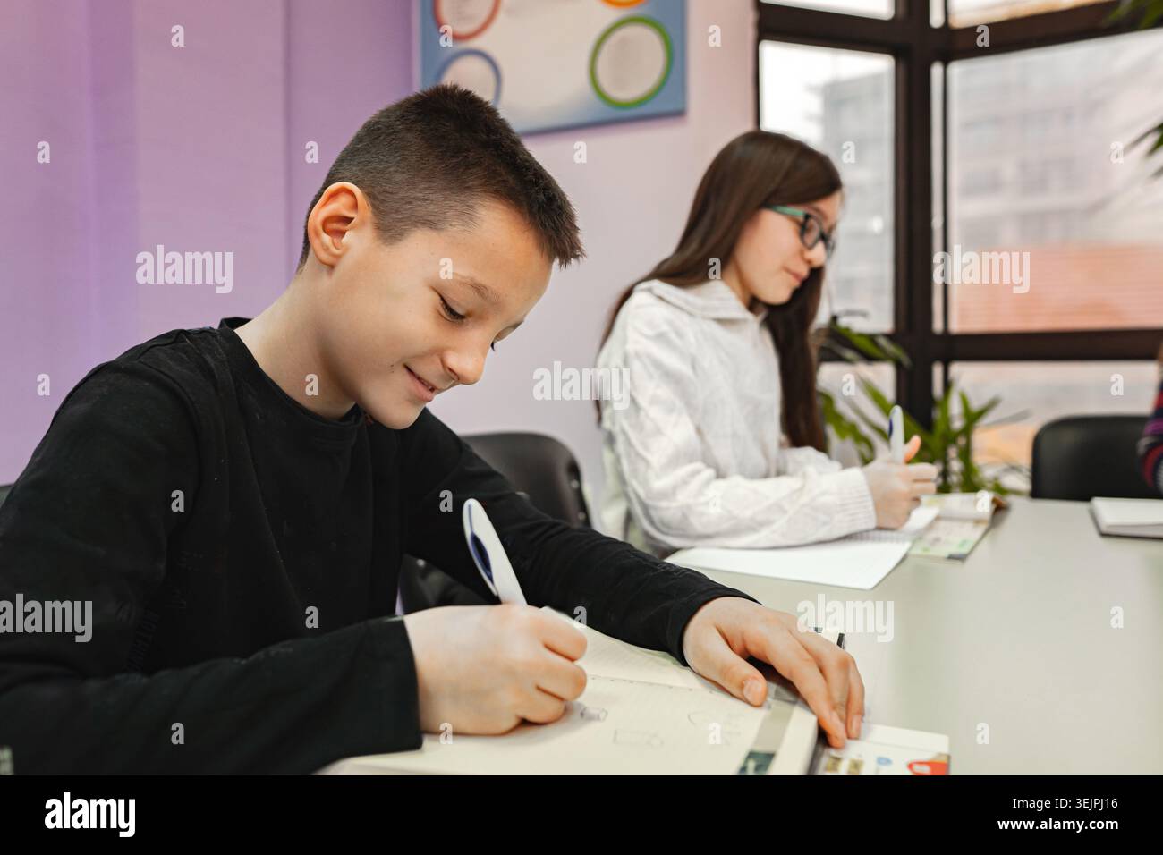 Two elementary students learning together at language school Stock Photo